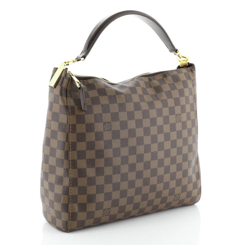 This Louis Vuitton Portobello Handbag Damier PM, crafted in damier ebene coated canvas, features a single looped leather handle and gold-tone hardware. Its top zip closure opens to a brown microfiber interior with side zip and slip pockets.