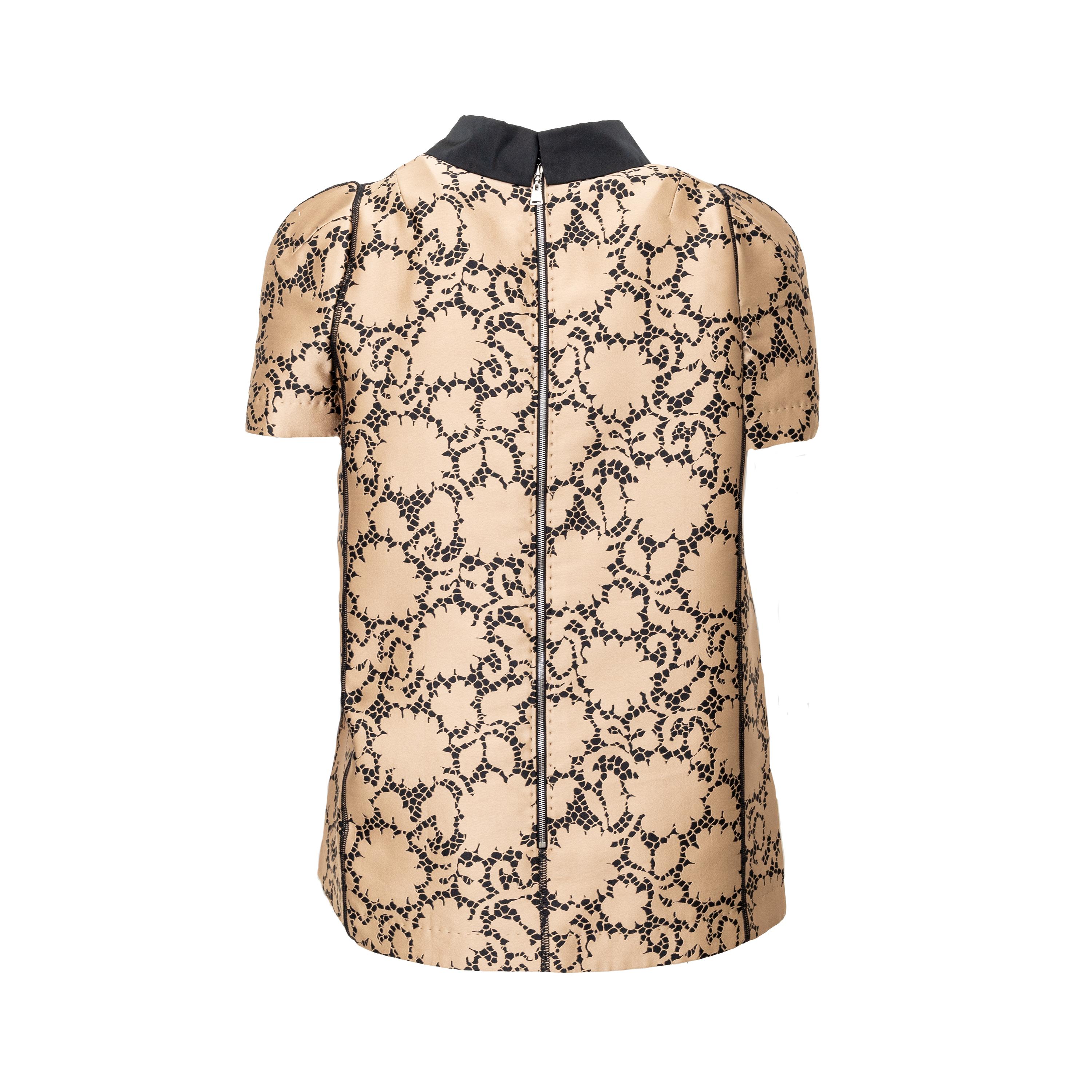 This elegant Louis Vuitton top is crafted from golden-bronze silk fabric adorned by a beautiful black lace print. The classic Peter Pan collar and unique pleated short sleeves create a sophisticated and puffy look. 
 
