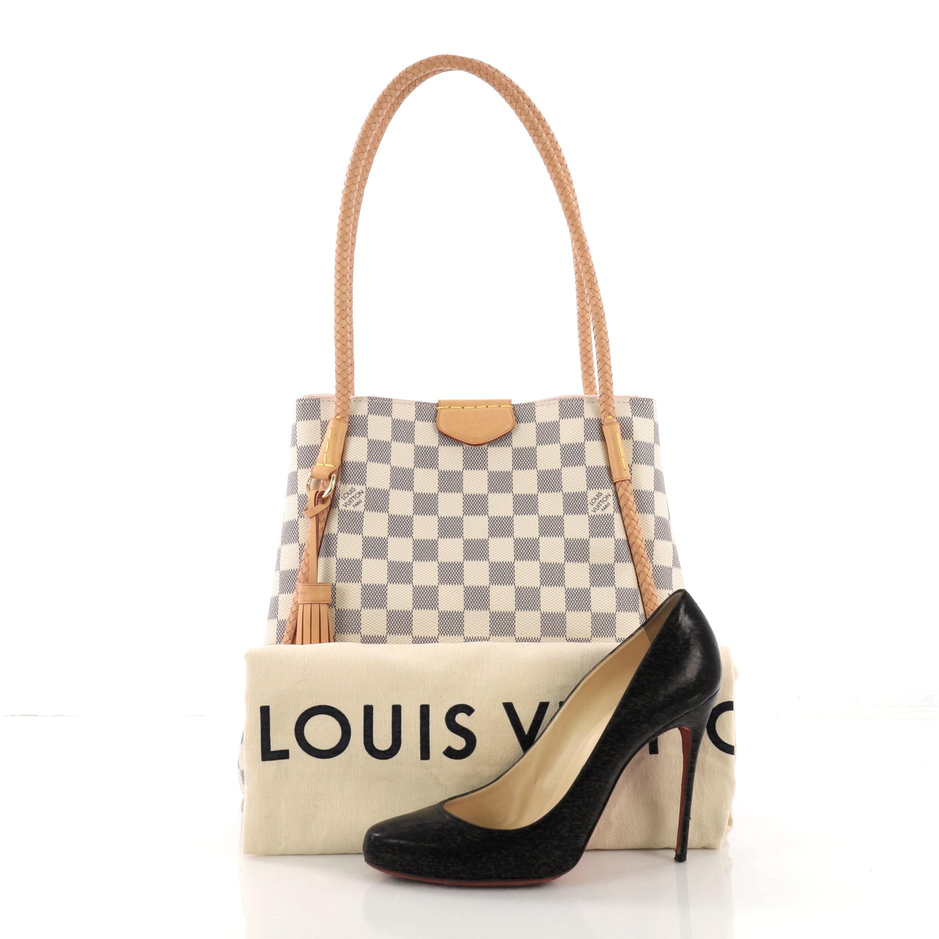 This Louis Vuitton Propriano Handbag Damier, crafted in damier azur coated canvas, features braided leather piping and handles, and gold-tone hardware. Its magnetic closure opens to a pink microfiber interior with zip pocket. Authenticity code