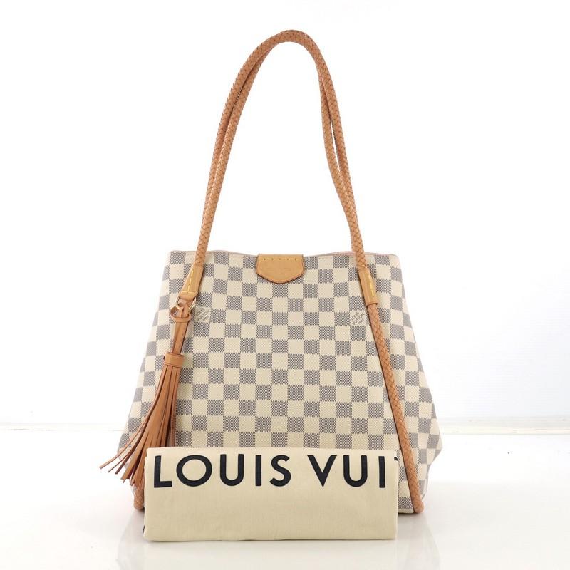 This Louis Vuitton Propriano Handbag Damier, crafted in damier azur coated canvas, features braided leather piping and handles, and gold-tone hardware. Its magnetic closure opens to a pink microfiber interior with zip pocket. Authenticity code