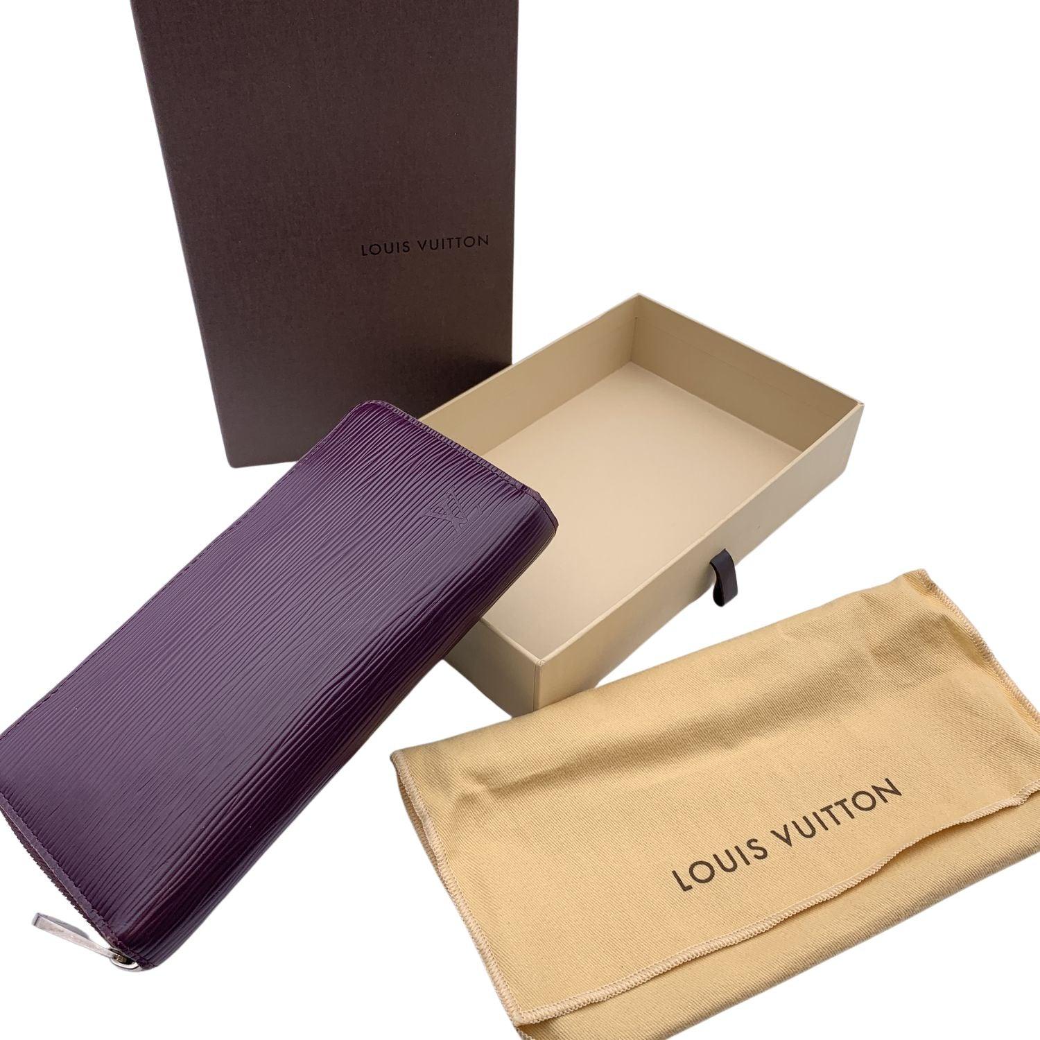 LOUIS VUITTON purple Epi Leather Zippy Wallet. Zip closure. It features 3 bill compartments, 1 zip coin compartment, 3 flat open pocket. 8 credit card slots. 'LOUIS VUITTON Paris - made in Spain' embossed inside. Authenticity serial number embossed