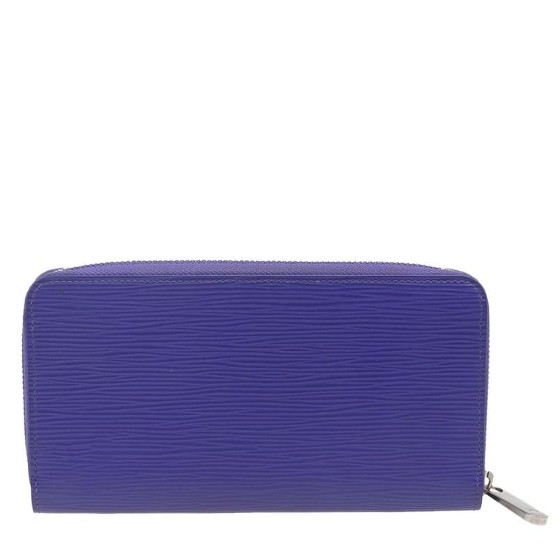 This Louis Vuitton Zippy wallet is conveniently designed for everyday use. Crafted from epi leather, the wallet has a zip closure that opens to reveal multiple slots, leather-lined compartments, and a zip pocket for you to neatly arrange your daily