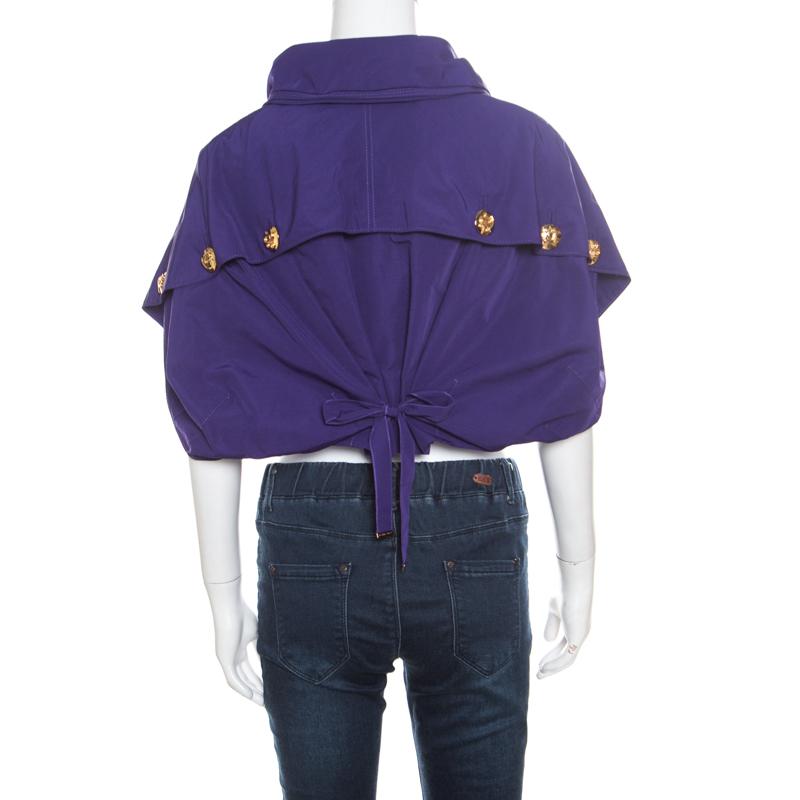 Elegant and ultra-modern are two words that pretty much define this Louis Vuitton shrug. It is a beautiful purple creation featuring a feminine, cropped silhouette with gathering detail accented with a bow at the rear. The shrug is styled with a