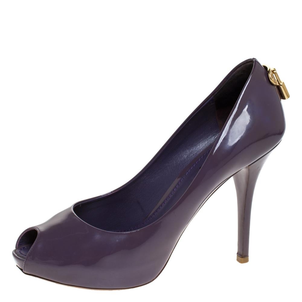 How splendid and glorious are these Oh Really! pumps from Louis Vuitton! Ravishing in purple, they come crafted from patent leather and feature a peep-toe silhouette. They flaunt an artistic engraved gold-tone padlock detailing on the counters and