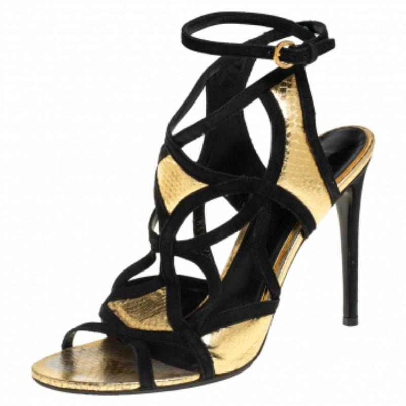 These gold and black ankle strap sandals from Louis Vuitton have been designed to lift your style. They flaunt python-embossed leather and suede trim cut-out straps to frame your feet and are elevated on 11 cm heels. Show them off with mid-length