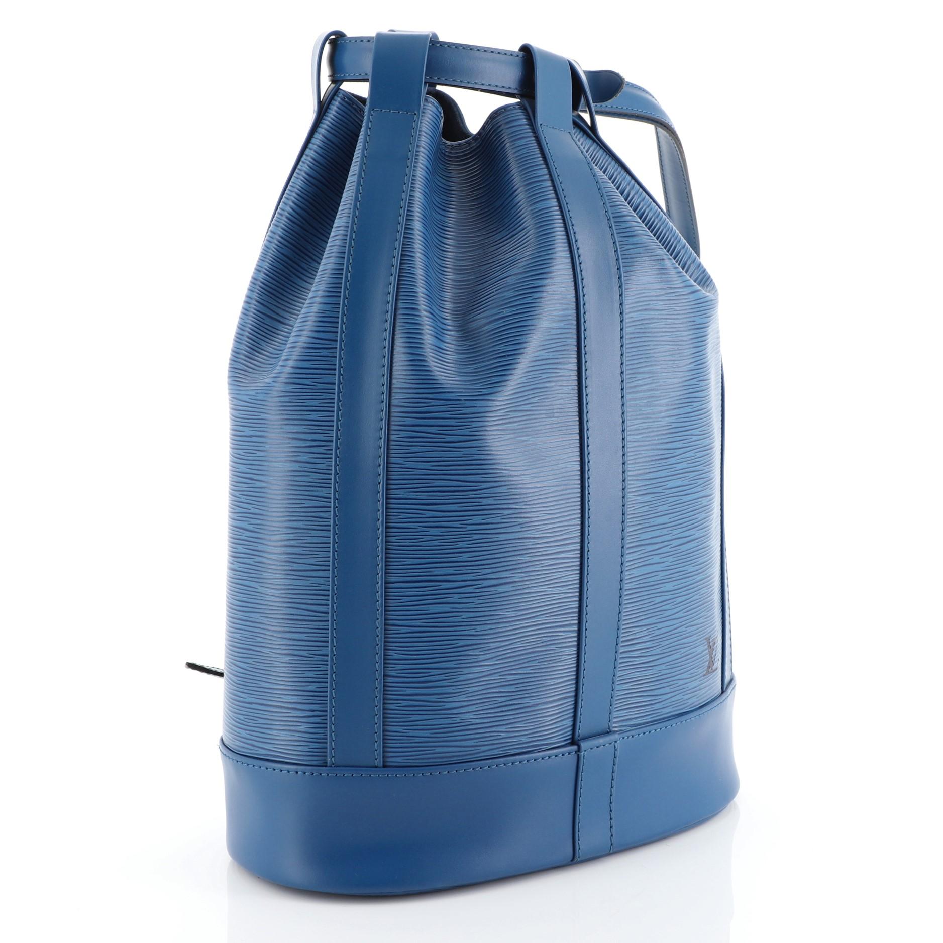 This Louis Vuitton Randonnee Backpack Epi Leather PM, crafted from blue epi leather, features adjustable leather cinch strap, subtle LV logo, and gold-tone hardware. Its cinch strap closure opens to a blue microfiber interior. Authenticity code