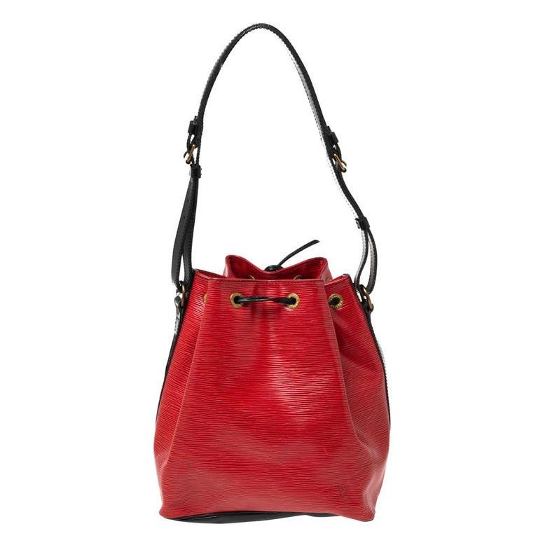 Created in 1932 by Louis Vuitton to carry bottles of Champagne, the iconic Noe now serves as a stylish daytime handbag. Crafted from red and black epi leather, the bag exudes just the right amount of sophistication. It has a single shoulder strap