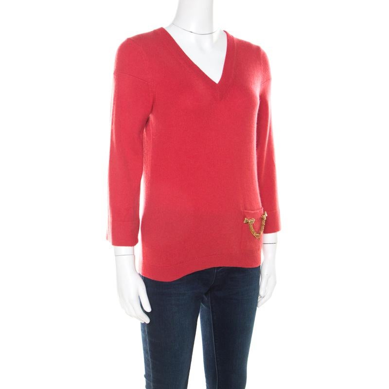 We are in love with this sweater from Louis Vuitton as it is stylish and warm at the same time. It is made from cashmere and designed with a V neckline, long sleeves, and the front pocket is embellished with gold-tone metal. You can wear it with