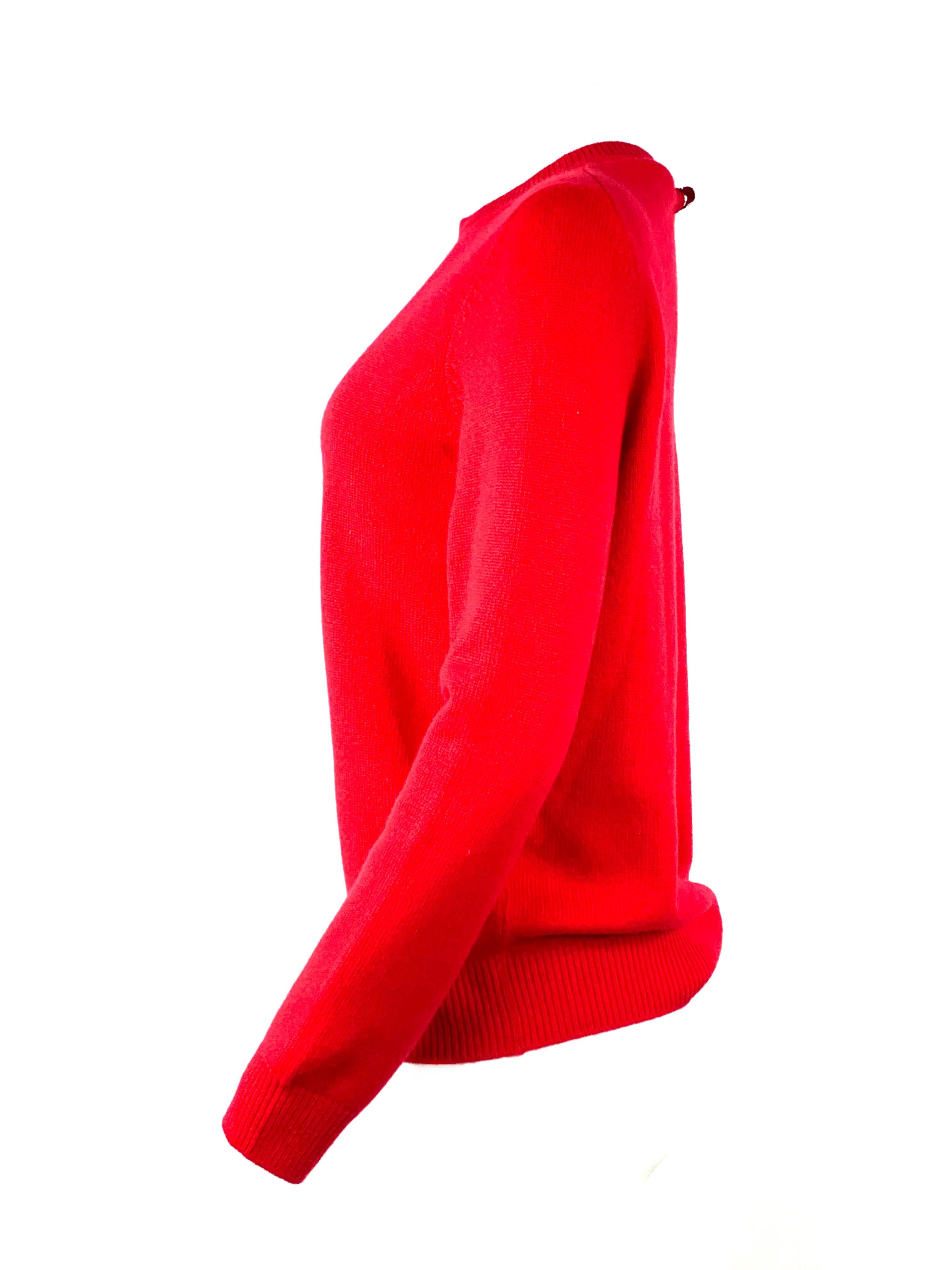 Louis Vuitton Red Cashmere Pullover Sweater Size S

Product details:
Size small
100% Cashmere
Silver tone hardware w/ LV flower logo detail on the back
Drop shape opening on the back, 8” long 
Long sleeves
Crew neck style
Made in Italy 
