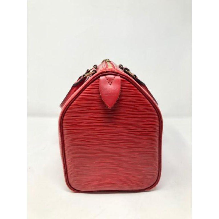 This holiday season, wearing this bright cherry red epi leather speedy by Louis Vuitton, you will stand out in the right way!  Be sustainable and keep this iconic bag worn and enjoyed. Light wear with a few surface scratches . Brass lock has