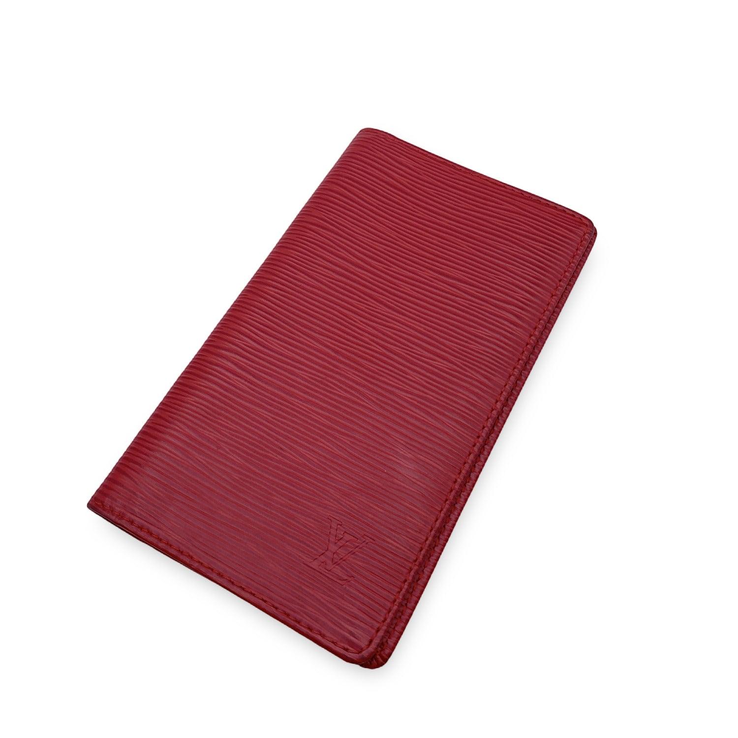 Louis Vuitton red epi leather Vertical Wallet. Red crossgrain leather inside. 2 side pockets and 3 credit card slots inside. Authenticity Serial Number CA0046 inside one of the pockets. 'LOUIS VUITTON Paris - made in Spain' embossed inside. Details