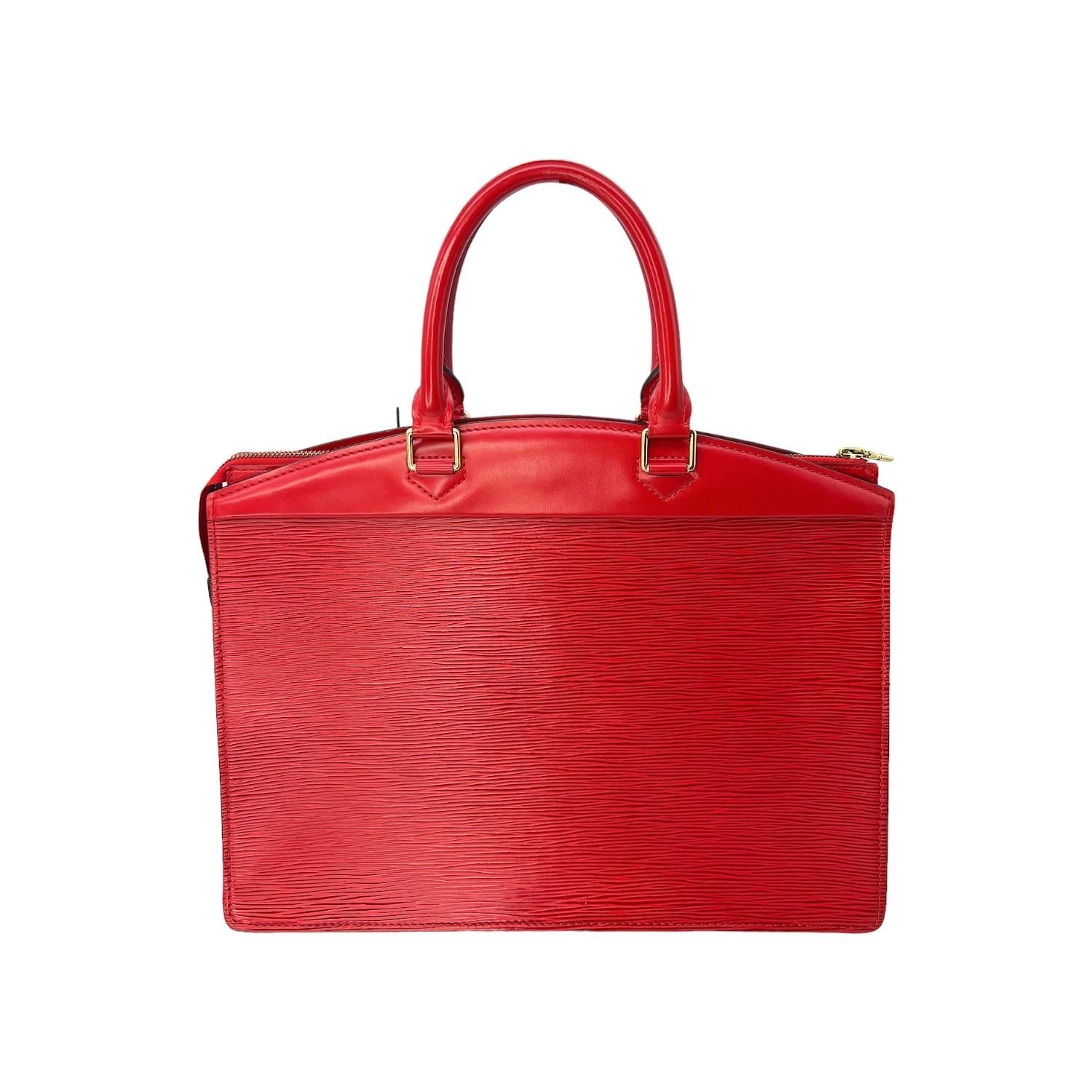 This beautiful Louis Vuitton Epi Riviera Handbag was made in France and it is finely crafted of a red epi leather exterior with leather trimming and gold-tone hardware features. It has a frontal zipper pocket. It has dual rolled leather top handles.