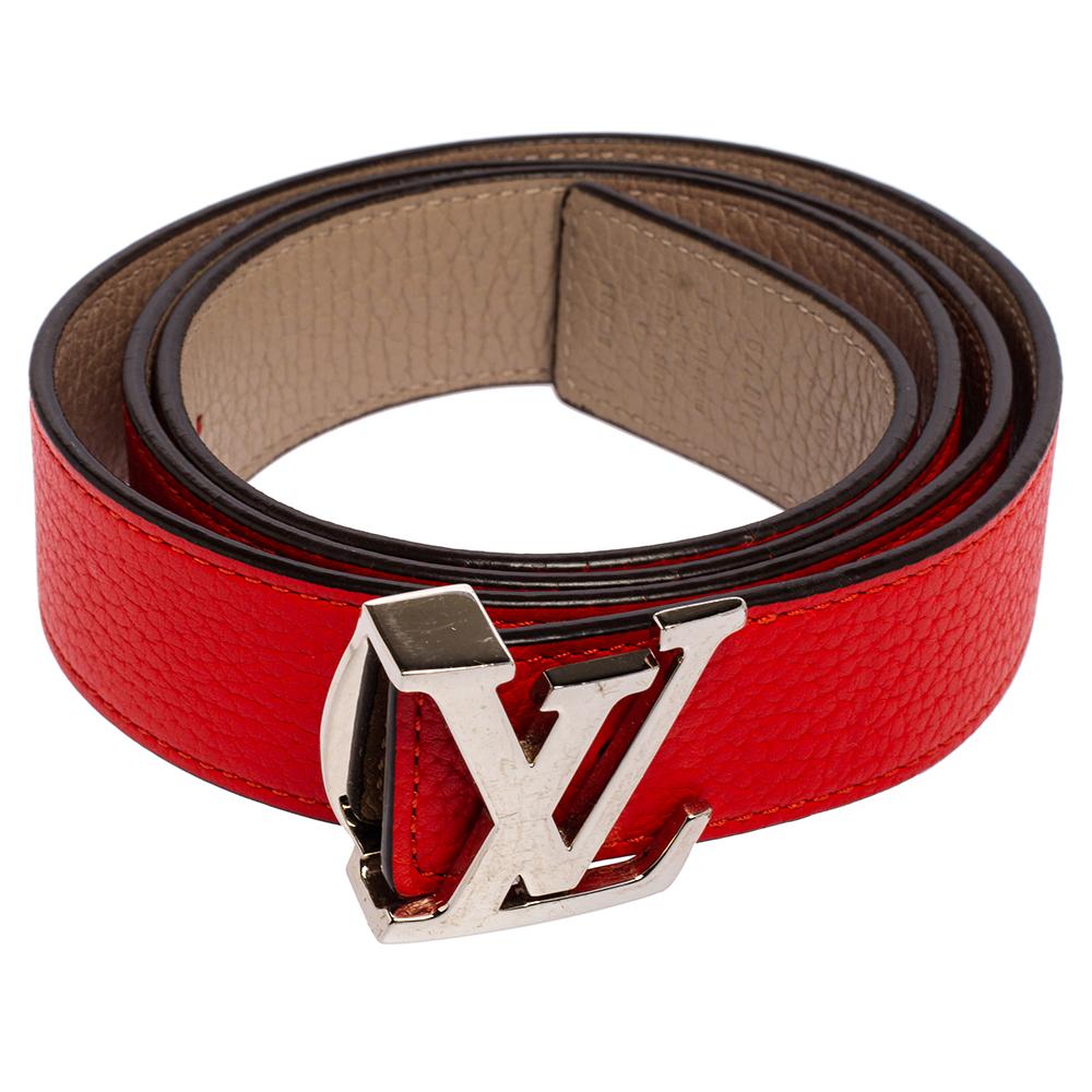 This stylish Initiales belt by Louis Vuitton is reversible with red leather on one side and beige on the other. It is finished with a silver-tone LV buckle that simply spells luxury.

Includes: Original Dustbag
