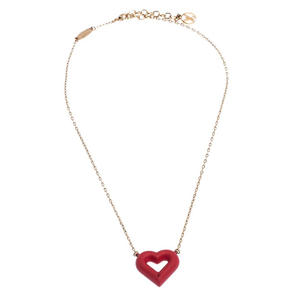 Dainty and elegant, this necklace from Louis Vuitton is a versatile beauty that can be worn to any occasion. Belonging to the Red Heart Collection, this necklace features a gold-tone chain that holds a red rubber heart charm detailed with the LV