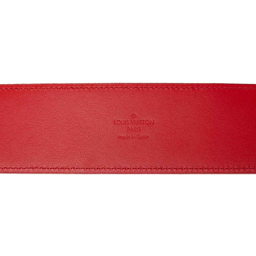 Add a luxurious touch to your ensemble by wearing this belt from the House of Louis Vuitton. Fashioned in red leather, this belt is adorned with a matching buckle on the front. It features gold-toned hardware and a length of 75 cm. This LV belt will