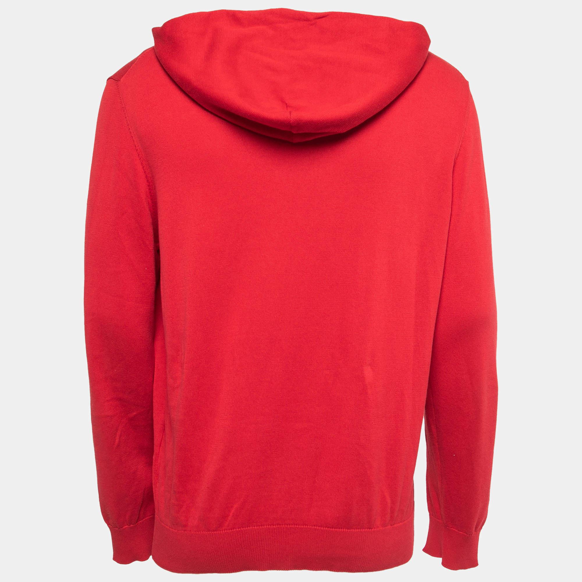 The Louis Vuitton sweater is a luxurious and stylish garment crafted with a blend of cotton and silk. It features a vibrant red color and showcases the iconic Louis Vuitton logo pattern. With a comfortable hood and knit construction, this sweater