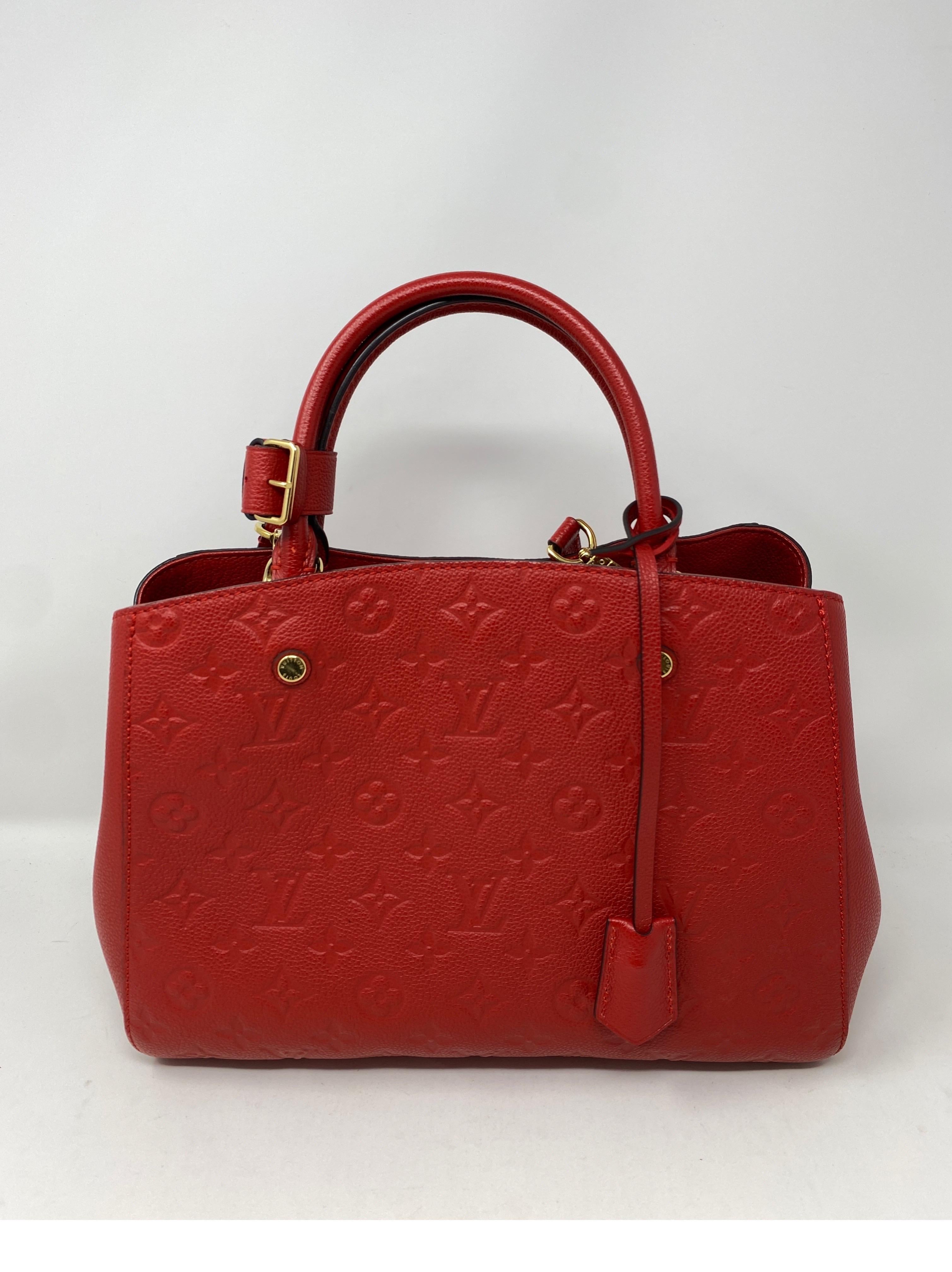 Louis Vuitton Red Montaigne MM Eimpreinte Leather Bag. Good condition. Includes detachable red leather strap. Guaranteed authentic. 