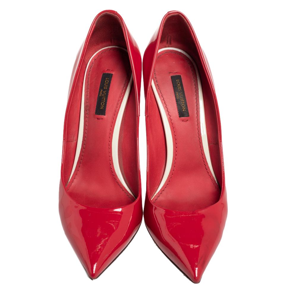 These Louis Vuitton pointed-toe pumps offer a timeless appeal. Perfect for work or casual events, they feature a red patent leather exterior, straight stiletto heels, and a chic gold-tone trim at the back with the brand name on it.


