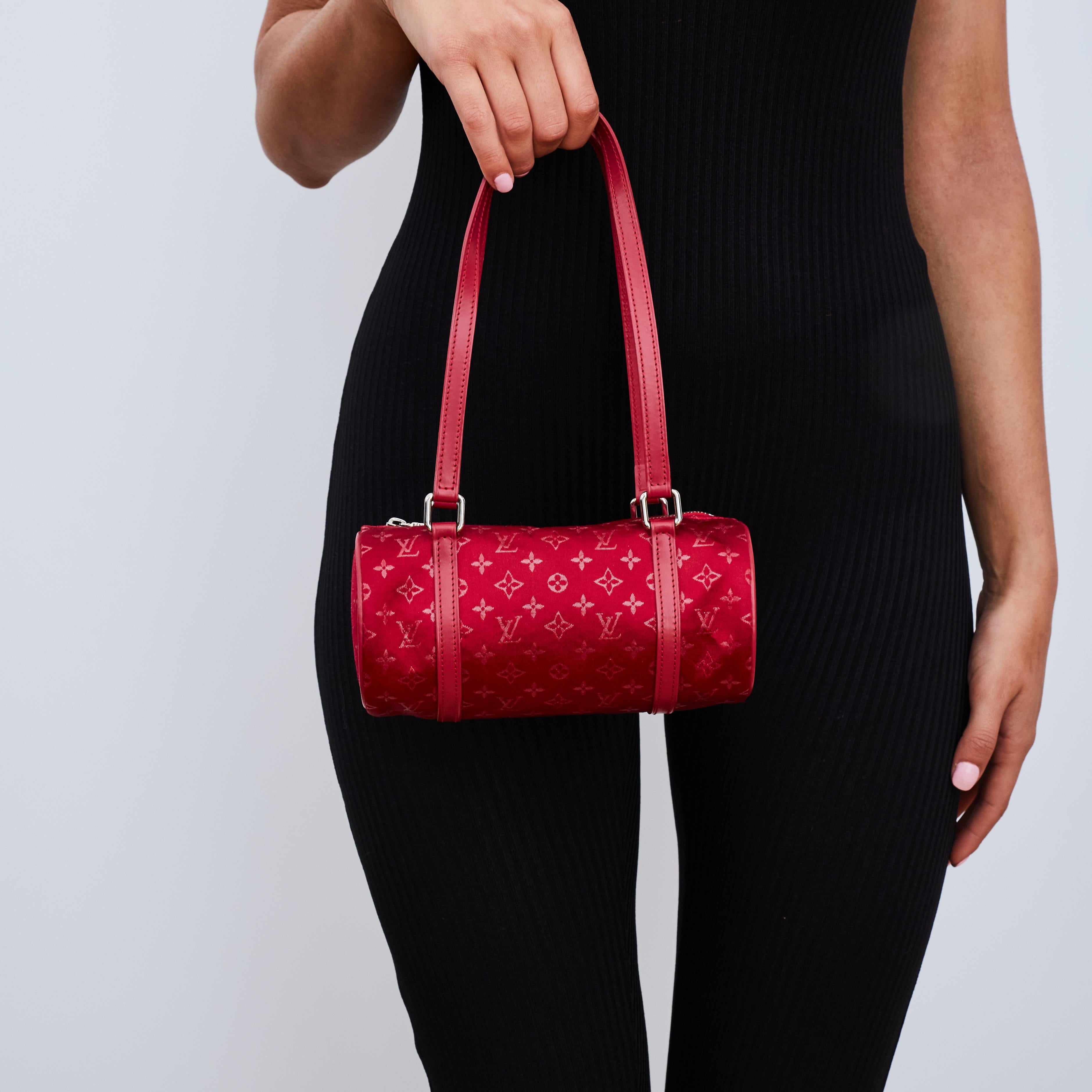 Louis Vuitton pre-loved mini Papillon handbag in a red monogram satin featuring red leather flat top handles, rolled leather trim, top zip closure and gunmetal silver-tone hardware.

Color: Red
Material: Satin
Year: 2002
Condition: Very good. Light