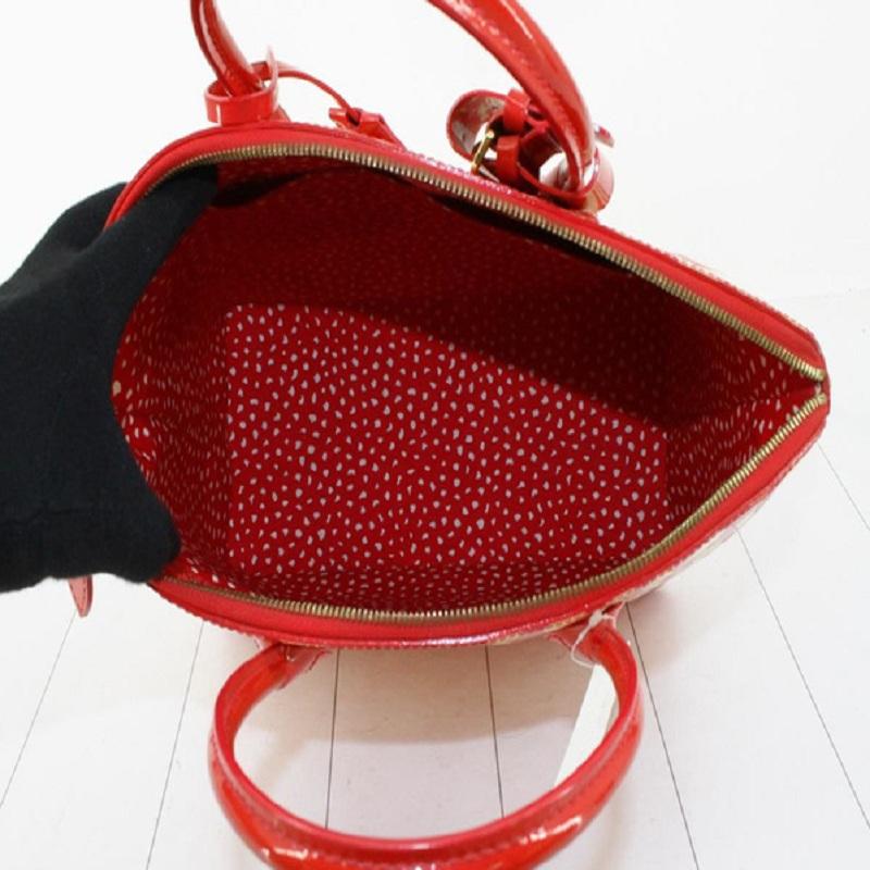 Red monogram Vernis leather with Yayoi Kusama's polka dot print Louis Vuitton Lockit Vertical MM satchel bag with gold-tone hardware, dual rolled handles, red printed canvas lining & three interior pockets, zip closure at top and protective feet at
