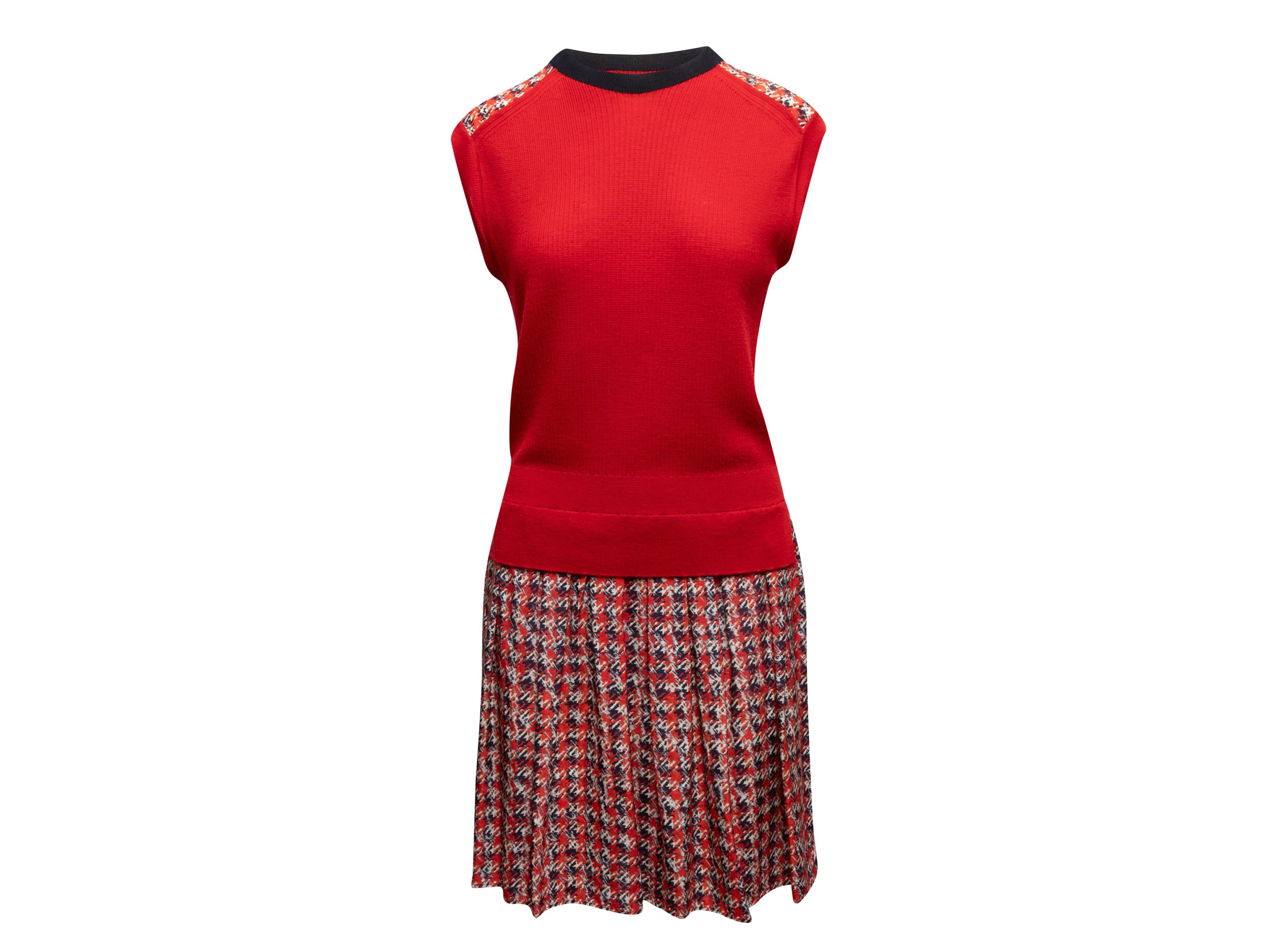 Red, black, and white wool and silk sleeveless dress by Louis Vuitton. Crew neck. Pleated houndstooth print skirt. Houndstooth print trim at shoulders. 42