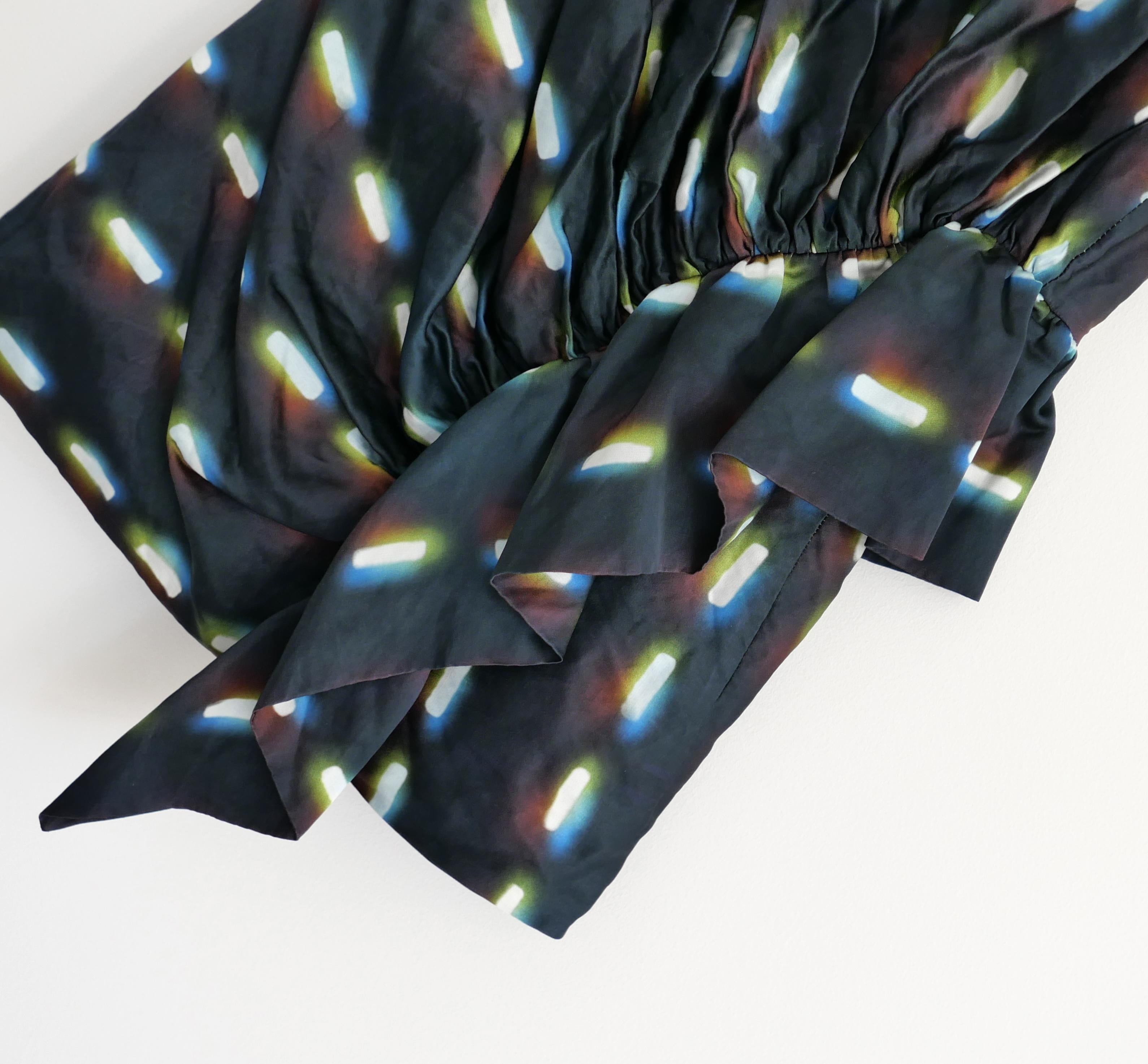 Stunning limited edition Dries Van Noten x Len Lye top. Worn once. Made from lightly crinkled viscose mix sateen with a striking street light inspired print. It has a semi fitted, sleeveless cut with ruched front and frilled side piece. Fully lined