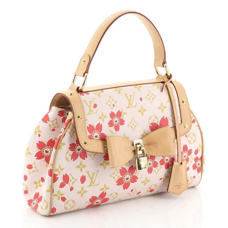 This Louis Vuitton Retro Bag Limited Edition Cherry Blossom Monogram, crafted in pink monogram cherry blossom coated canvas with natural cowhide leather trims, features a flat leather handle, studded detailing and gold-toned hardware. Its top flap