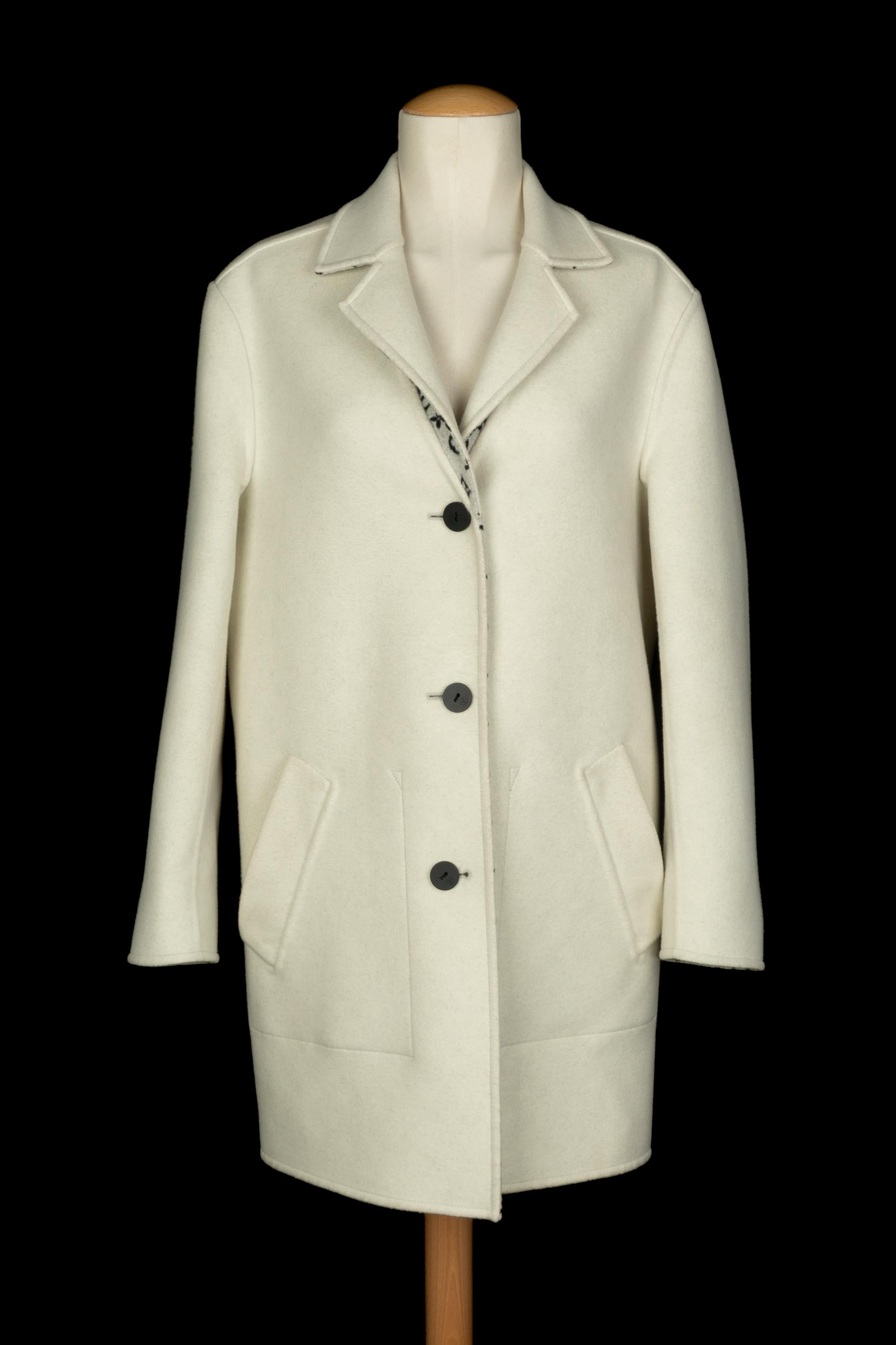 LOUIS VUITTON - (Made in Italy) Cappotto reversibile in seta e lana bianca con Monogram nero su sfondo bianco e tasche in pelle d'agnello nera. Indicata la taglia 34FR. A Collection'S circa 2020, sotto la direzione artistica di Nicolas