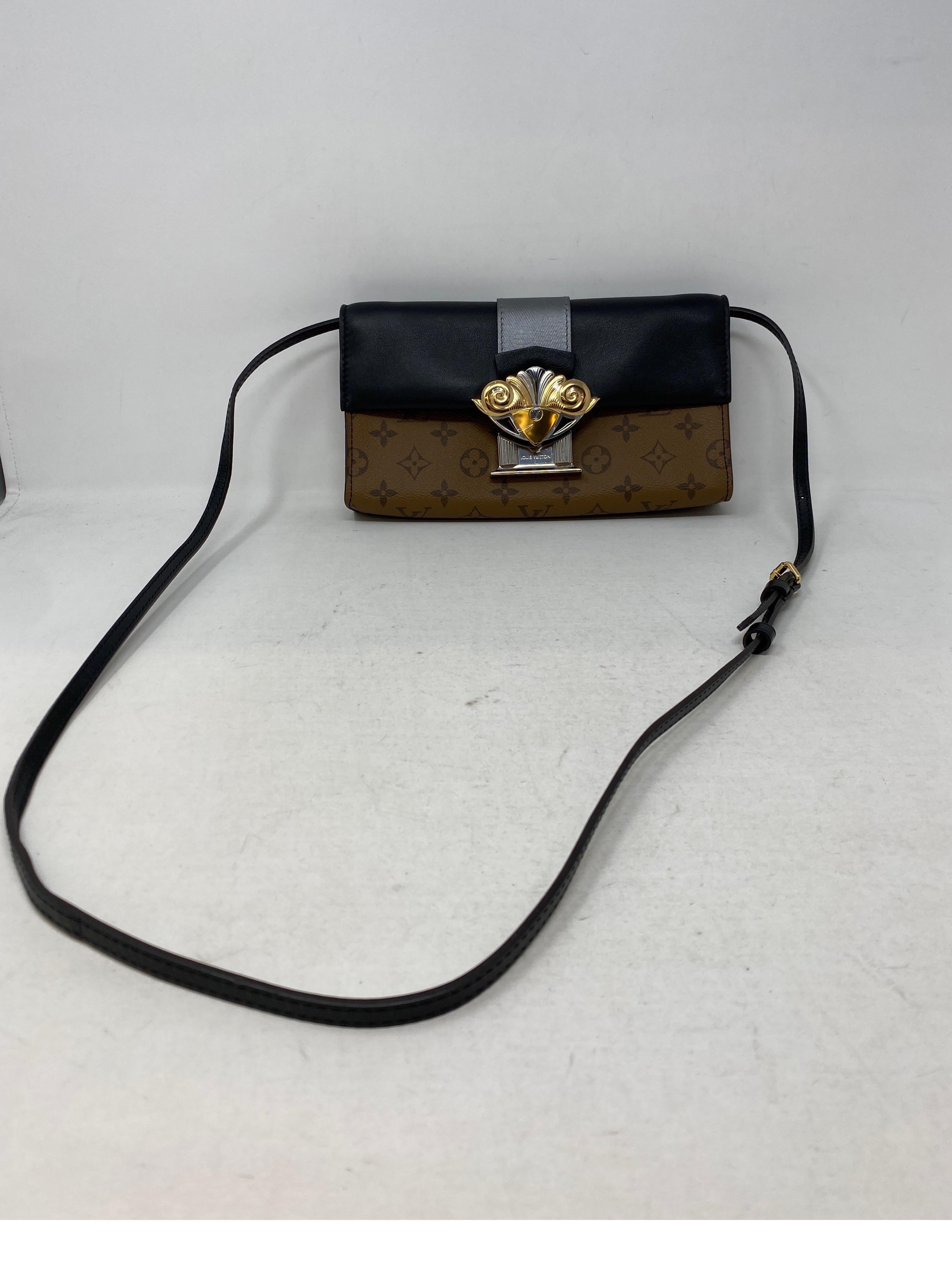 Louis Vuiton Reverse Monogram Clutch/ Evening Bag. Can be worn crossbody or as a clutch. Plastic still on hardware. New condition. Unique column style clasp. Gold and silver hardware. Includes dust cover and box. Guaranteed authentic. 