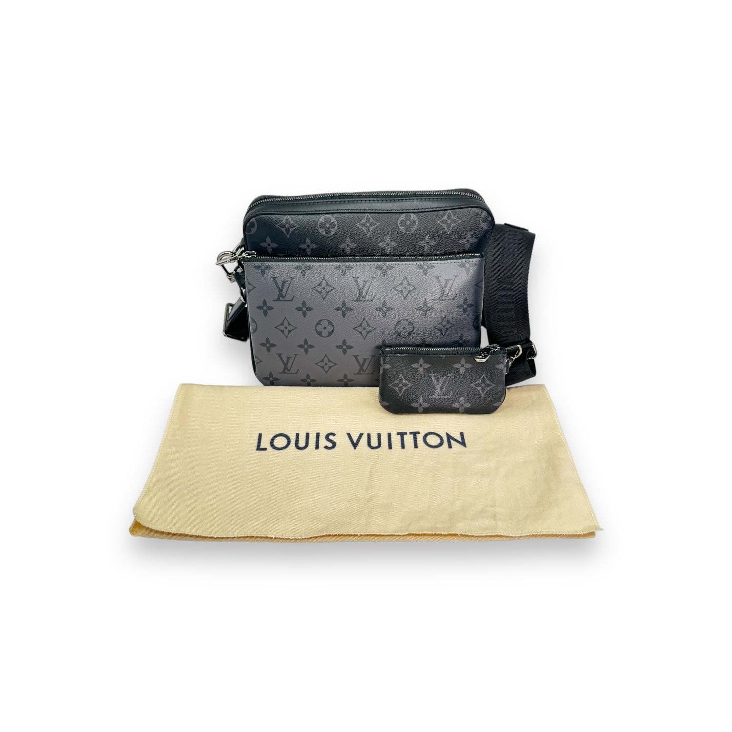 The Louis Vuitton Reverse Monogram Eclipse Trio Messenger Bag is a designer piece crafted in France with monogram eclipse and reverse coated canvas. With a microchip for authenticity, this bag also features cow-hide leather trim and a spacious