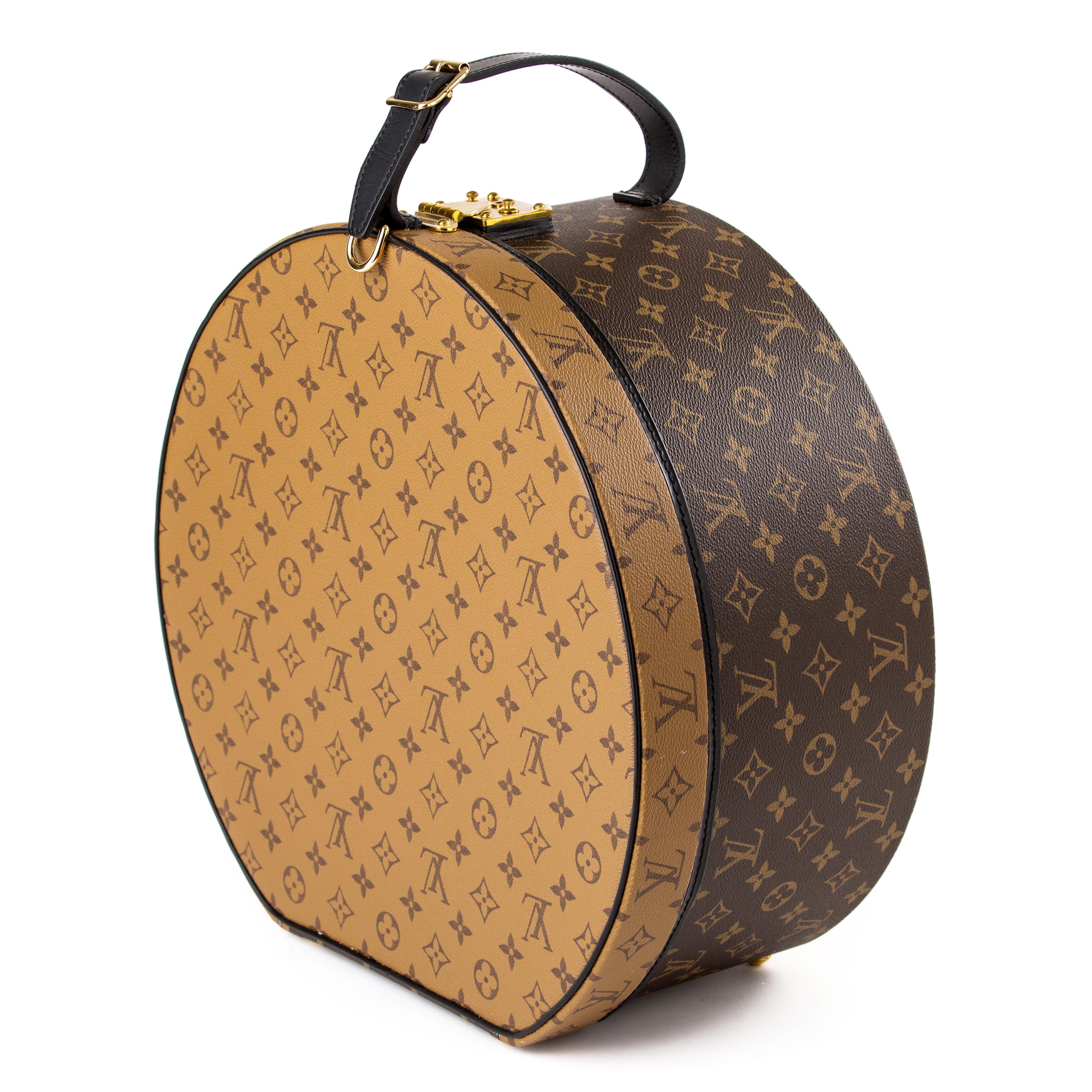Louis Vuitton reverse monogram hat box.

Very rare item.
Featured a reserve monogram lid.
The hat box features brass hardware and black leather trim.
 