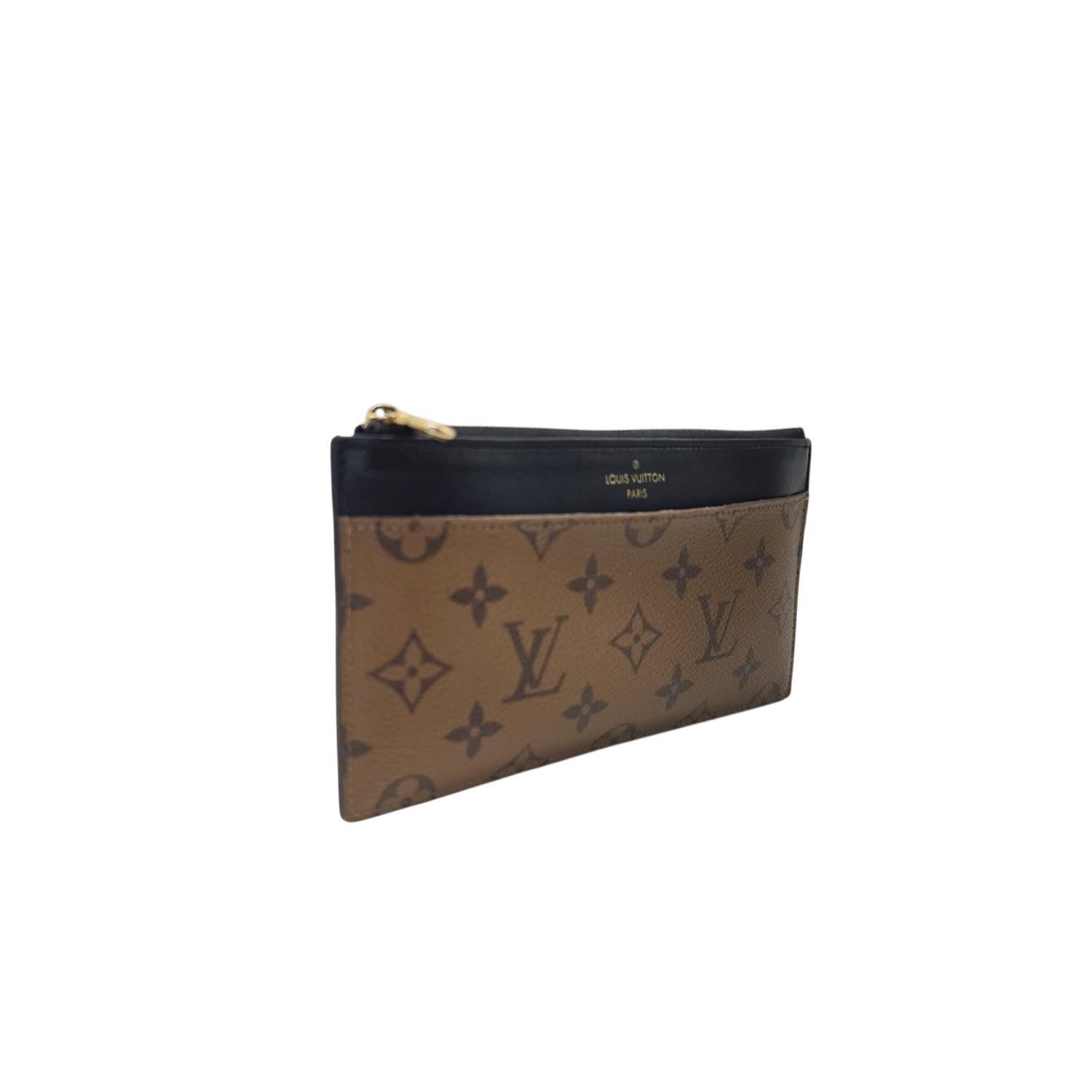 The Louis Vuitton Reverse Monogram Slim Purse features coated canvas with black leather trim and a gold-tone zipper. It includes eight card slots, a full slip pocket, a top zip compartment, and an exterior slip pocket, all designed for sleek and