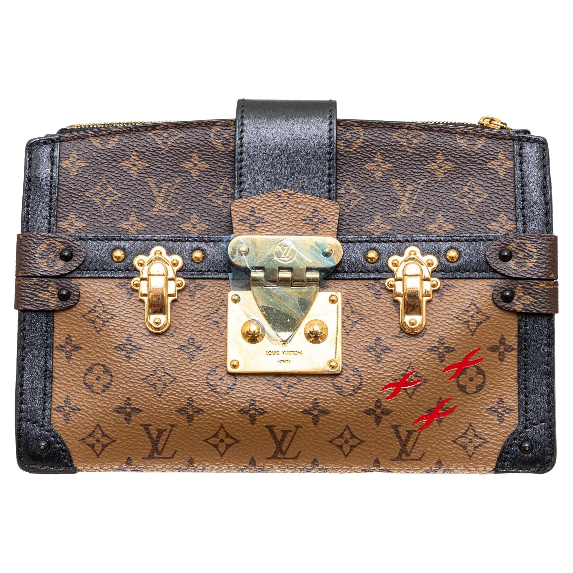 How do I attach a strap to a Louis Vuitton clutch?