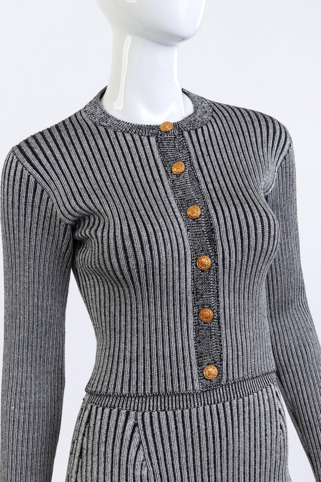 LOUIS VUITTON RIBBED KNIT TRUMPET CARDIGAN & SKIRT SET (US 2-4)

This Louis Vuitton ribbed knit set includes a cropped cardigan and high-waist skirt, both featuring a striped rib knit design with a metallic-like sheen. The cardigan is designed with