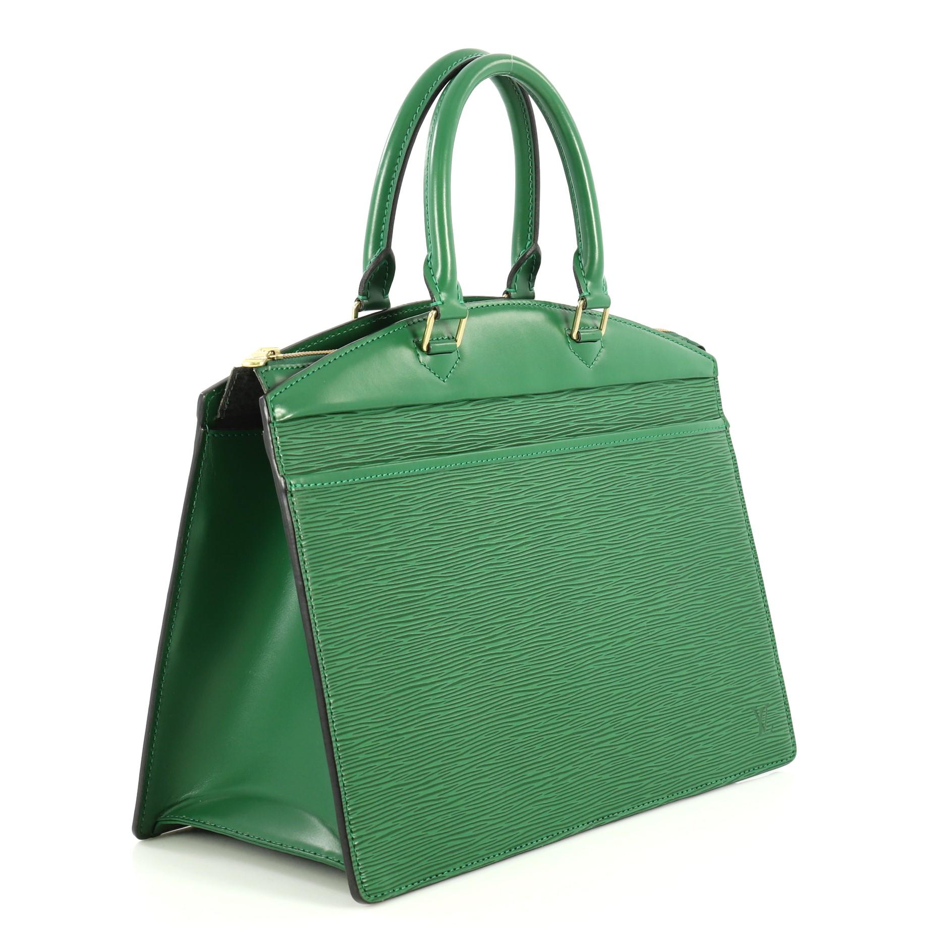 This Louis Vuitton Riviera Handbag Epi Leather, crafted from green epi leather, features dual rolled leather handles, full-length exterior front pocket, subtle LV monogram side logo, and gold-tone hardware. Its top zip closure opens to a gray