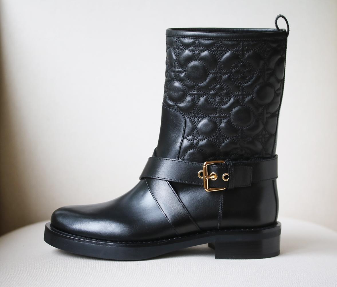 Louis Vuitton 'Roadgame' boots shot to the top of our wish list the moment we saw them. Made in Italy, they're crafted from smooth black leather adorned with Louis Vuitton's iconic flower monogram. Black shearling lined and gold metal buckle. Heel