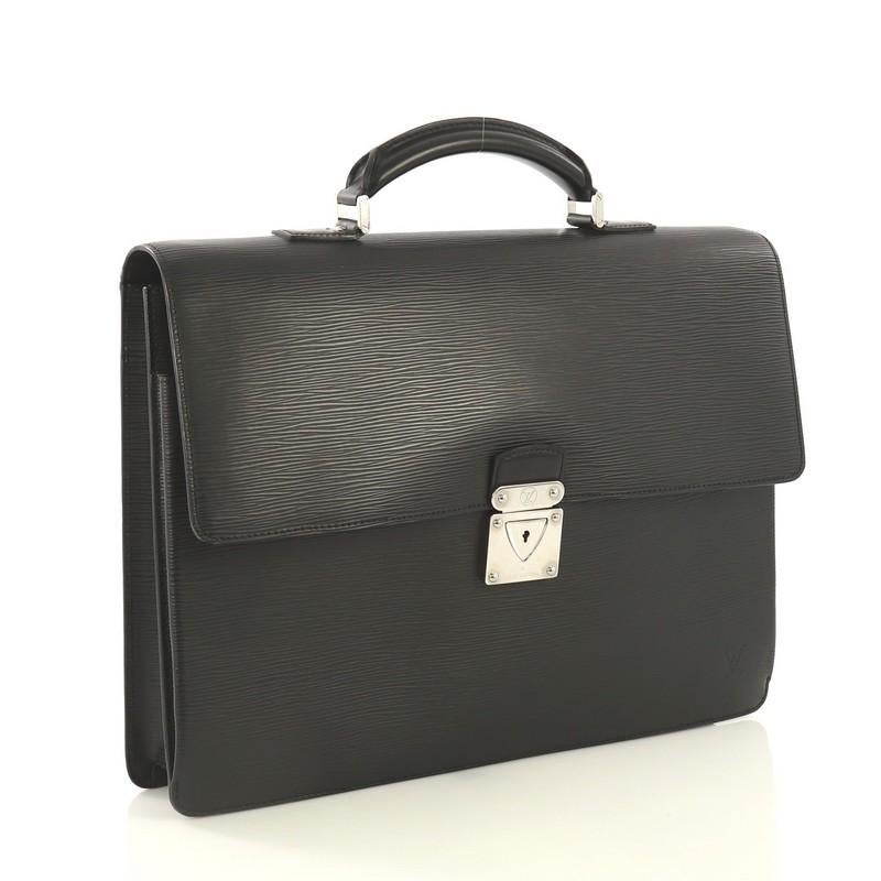 This Louis Vuitton Robusto 2 Briefcase Epi Leather, crafted from black epi leather, features a leather top handle, subtle LV logo, accordion-like sides, and silver-tone hardware. Its push-lock flap closure opens to a gray fabric interior with