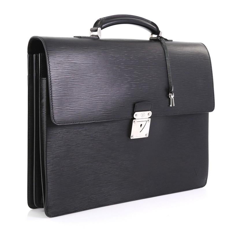 This Louis Vuitton Robusto 2 Briefcase Epi Leather, crafted from black epi leather, features a leather top handle, subtle LV logo, accordion-like sides, and silver-tone hardware. Its push-lock flap closure opens to a black fabric interior with