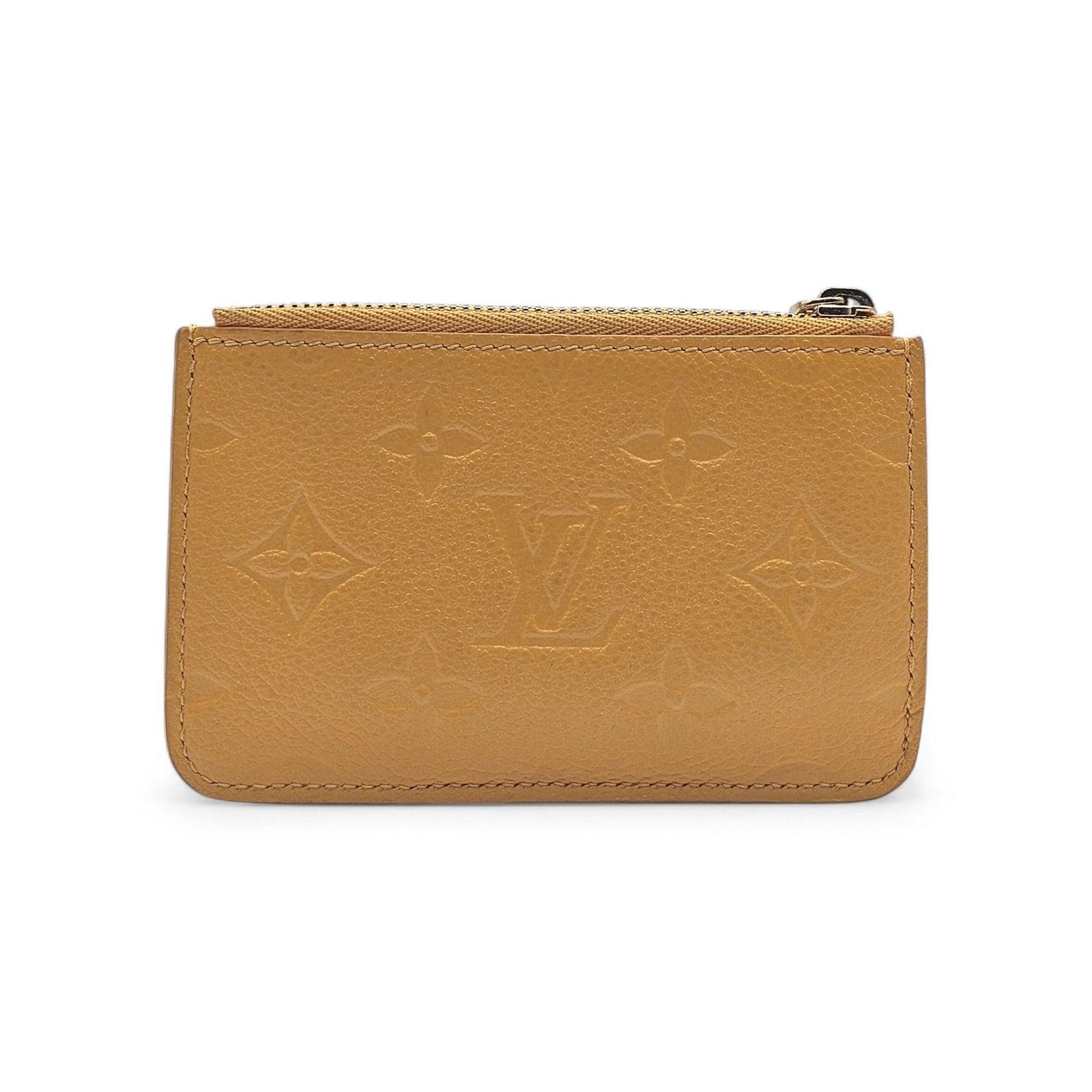 The Louis Vuitton Romy Card Holder in Jaune d’Or Yellow is a stunning blend of elegance and functionality. Crafted from supple, grained Monogram Empreinte cowhide leather, this sleek accessory features the iconic Monogram embossing and vibrant