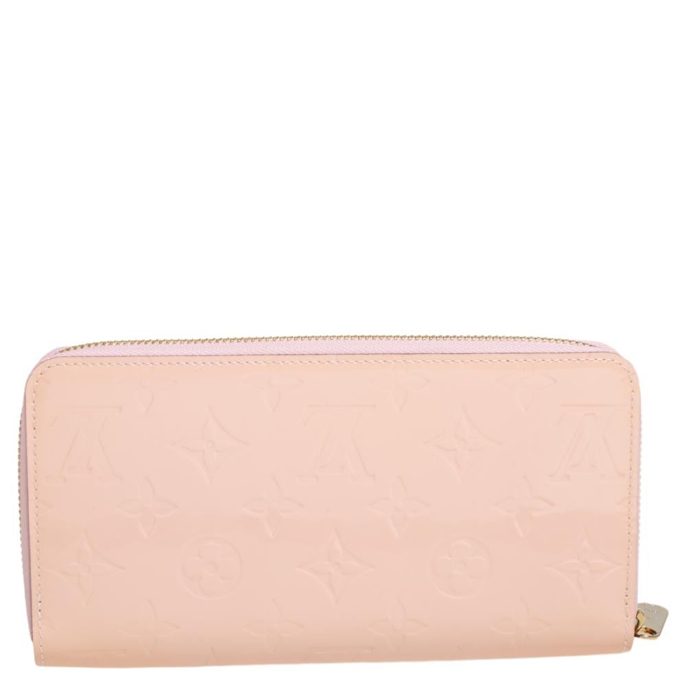 This Louis Vuitton Zippy wallet is conveniently designed for everyday use. Crafted from Monogram Vernis, the wallet has a wide zip closure that opens to reveal multiple slots, leather, and fabric-lined compartments and a zip pocket for you to neatly