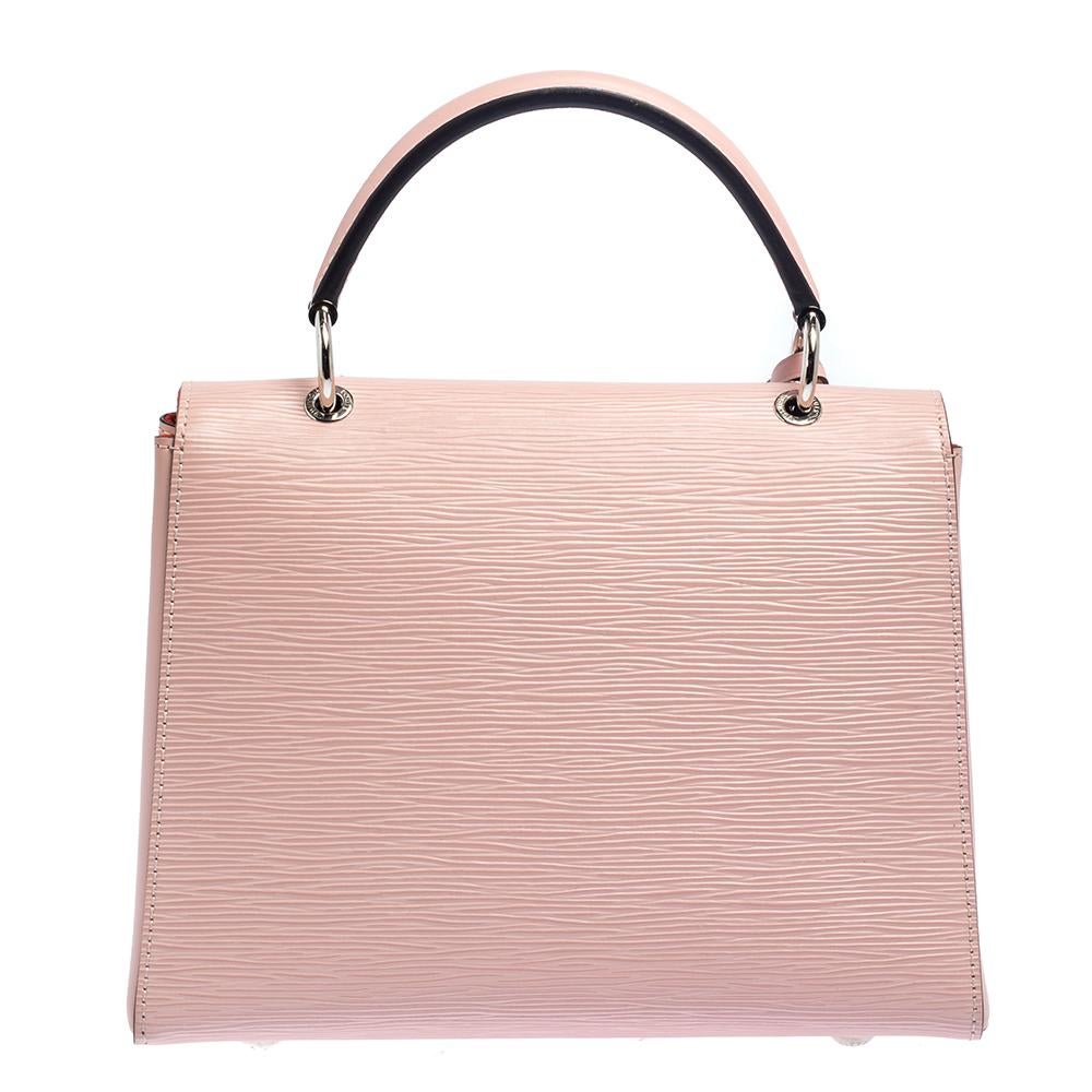 A perfect balance of chic style and minimalism, the Grenelle bag is an ideal pick for everyday use. A delightful piece to own, it features a rose pink epi leather body and carries a matching LV logo on the front flap. It comes with a single top
