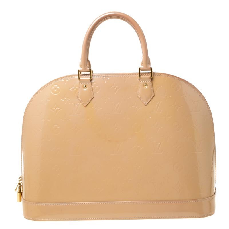 Out of all the irresistible handbags from Louis Vuitton, the Alma is the most structured one. First introduced in 1934 by Gaston-Louis Vuitton, the Alma is a classic that has received love from icons. This piece comes crafted from Monogram Vernis,