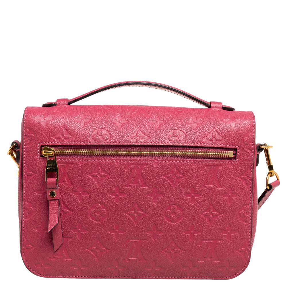 This attractive Louis Vuitton Pochette Metis Bag is a statement in itself. Fashioned in Monogram Empreinte leather, this piece is styled with a front flap and a gold-tone push-lock closure. A top handle and a detachable shoulder strap complete the
