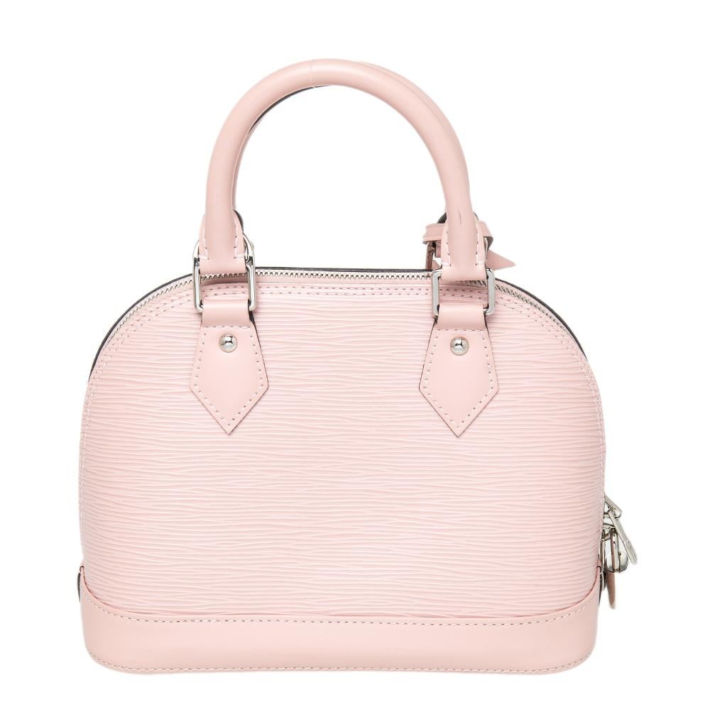A classic from the house of Louis Vuitton, the shape of the Alma stands out. Louis Vuitton's Alma was named after the Alma Bridge that connects Paris' fashionable neighborhood. The bag is crafted from Epi leather and it features protective metal