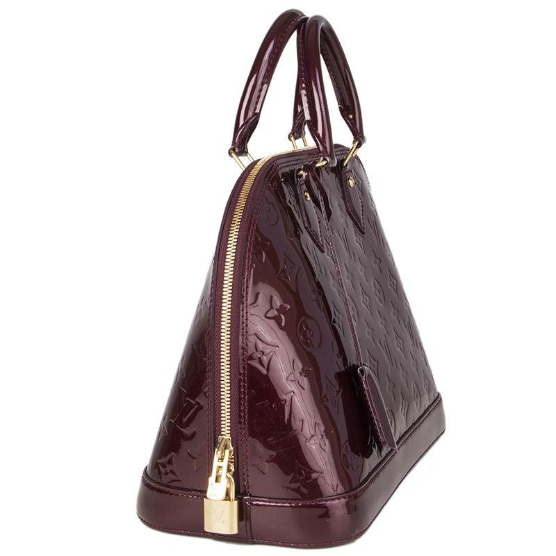 Louis Vuitton 'Alama PM' in Rouge Fauviste Monogram Vernis patent leather. Closes with a double zipp on top. Lined in canvas with two open pockets against the back. Has been carried and is in excellent condition. Comes with keys and lock.

Height