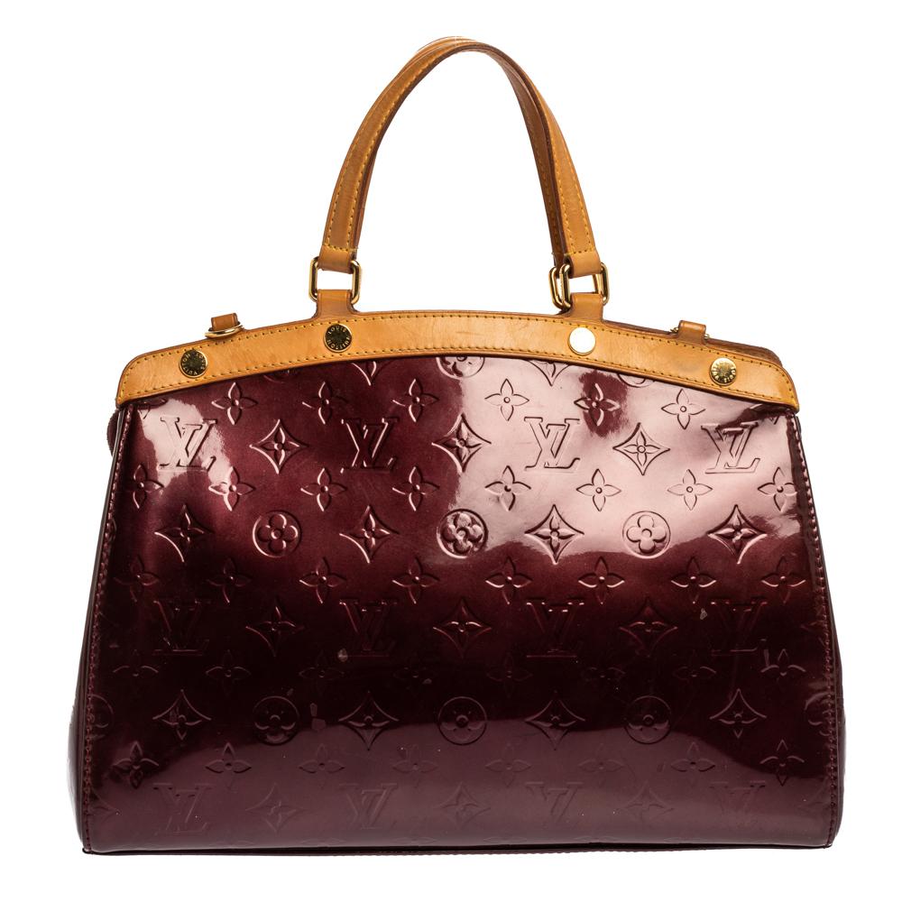 The feminine shape of Louis Vuitton's Brea is inspired by the doctor's bag. Crafted from Monogram Vernis and leather, the bag has a perfect finish. The fabric interior is spacious and it is secured by a zipper. The bag features double handles,
