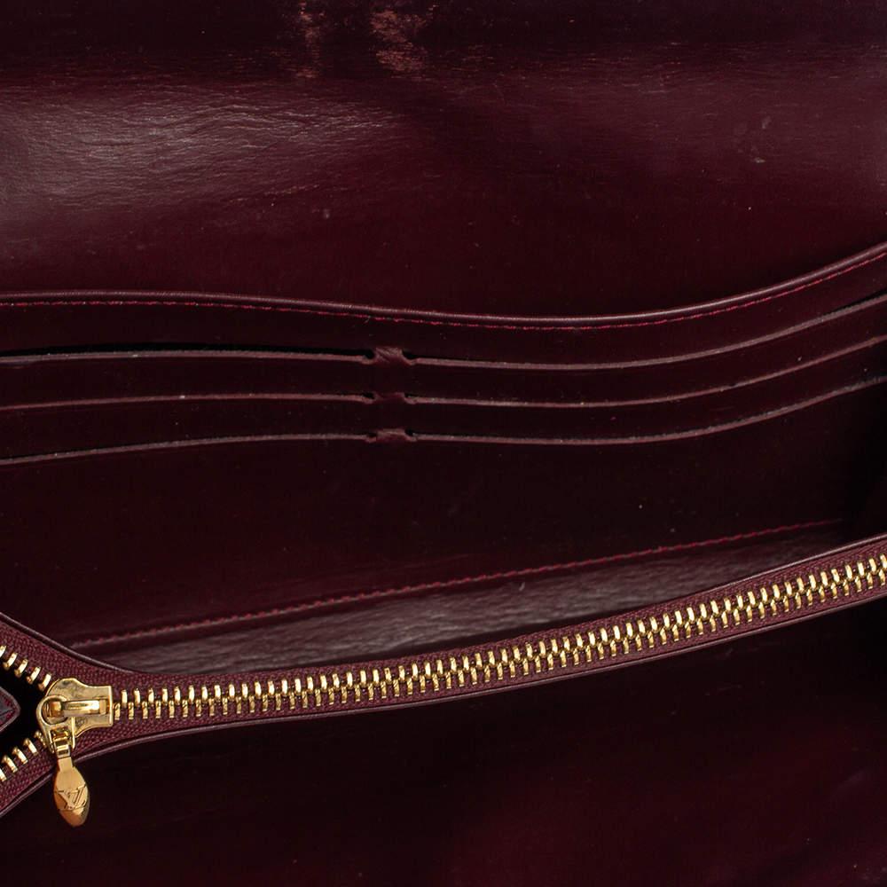 One of the most famous wallets by Louis Vuitton is the Sarah. This one here comes made from Monogram Vernis leather and the button on the flap opens to an interior with multiple card slots and a flap pocket. Perfect in size, this wallet can easily