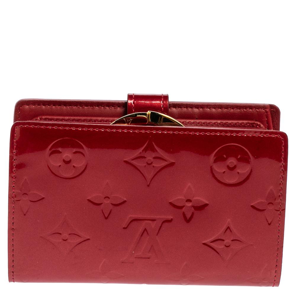 This fabulous French Purse from the house of Louis Vuitton is functional and stylish. It is made from monogram Vernis leather and lined with leather. The buttoned closure opens to multiple card slots, open compartments to arrange your cash and it