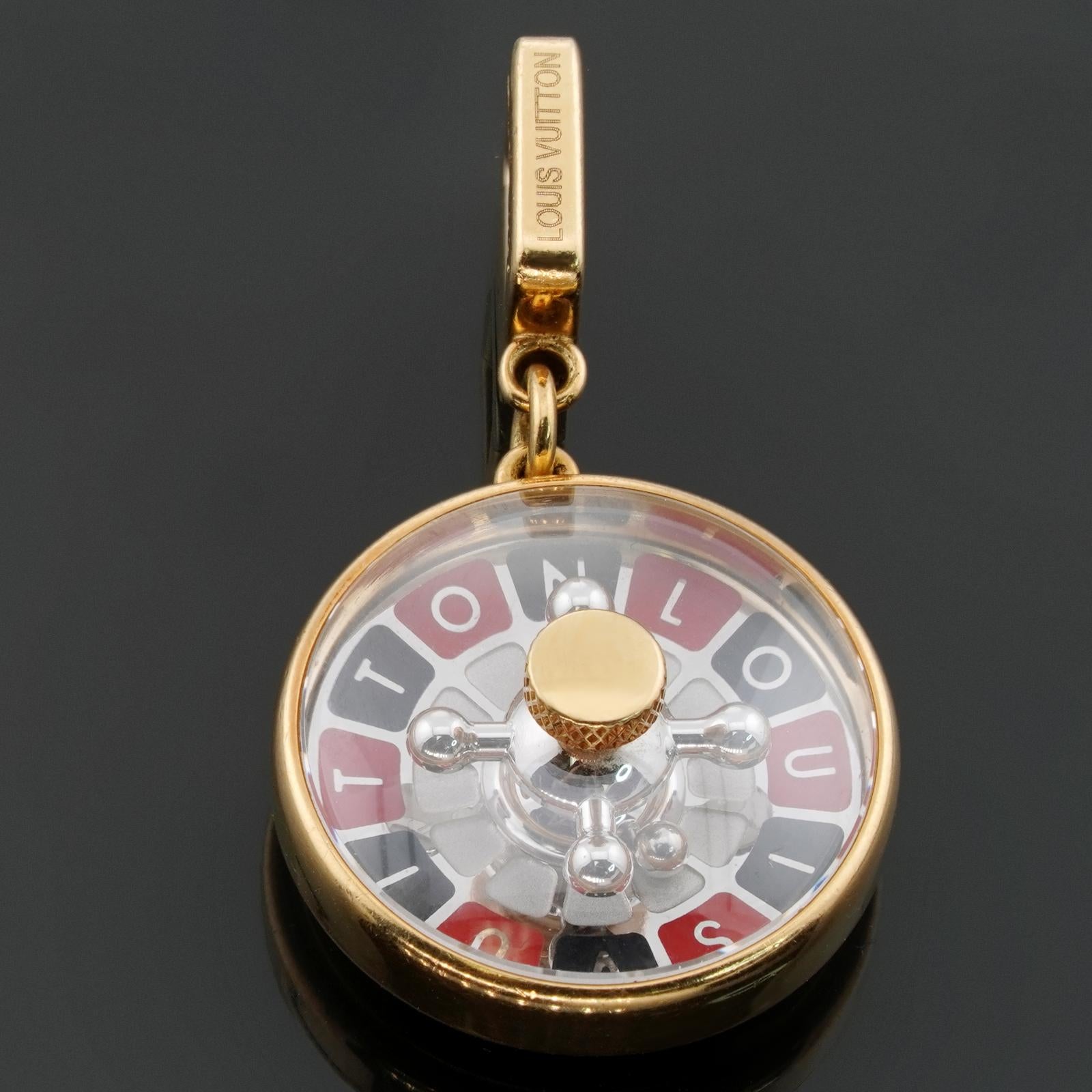This gorgeous authentic Louis Vuitton charm features white gold a roulette game wheel set in a round yellow gold frame enclosed with a sapphire crystal cover. The back us completed with a Good Luck engraving.  Made in France circa 2010s.