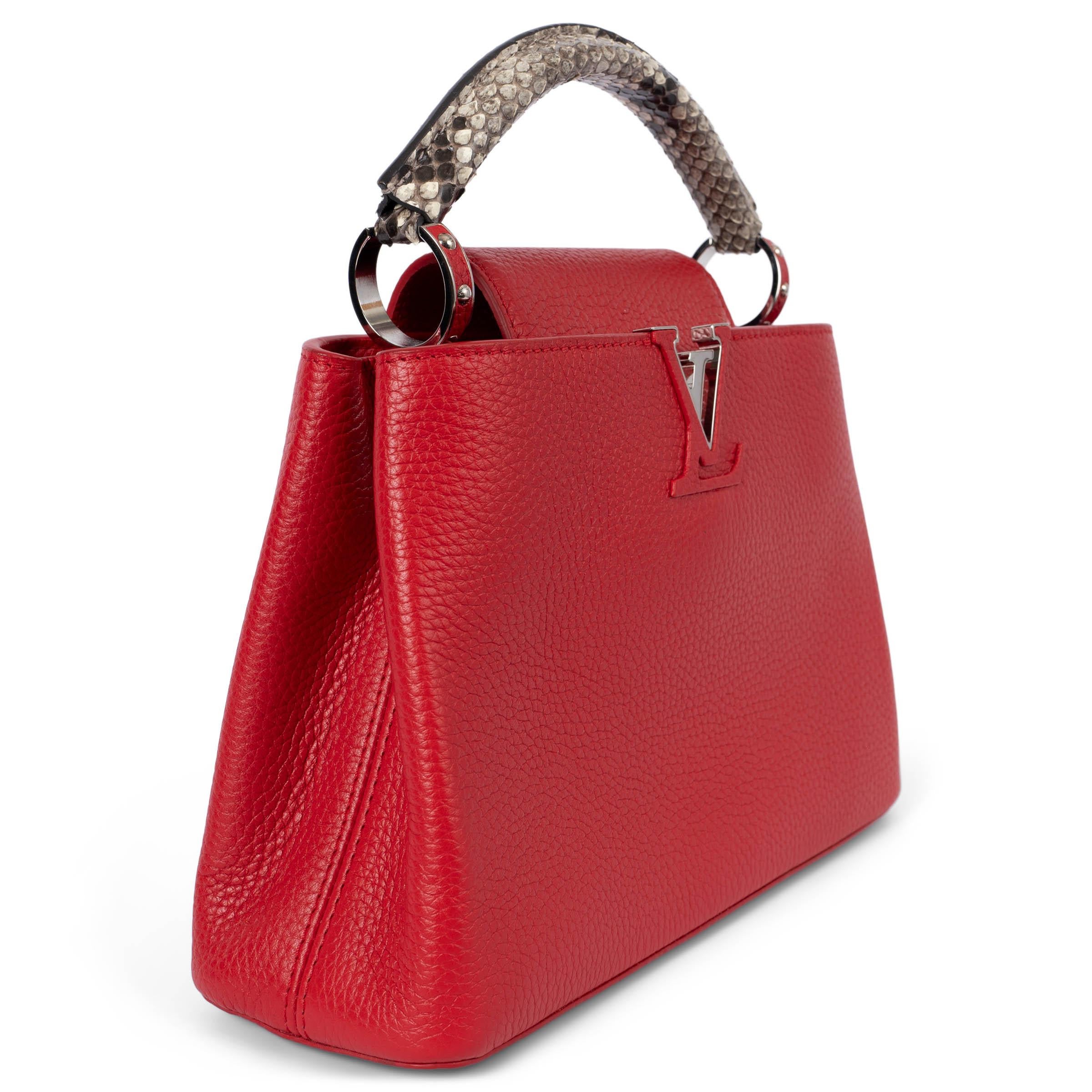 100% authentic Louis Vuitton Capucines BB bag in Rubis red full-grain Taurillon leather, it features a distinctive flap which can be worn two ways: outside to reveal a Monogram Flower, or inside to display the leather-wrapped LV Initials. This